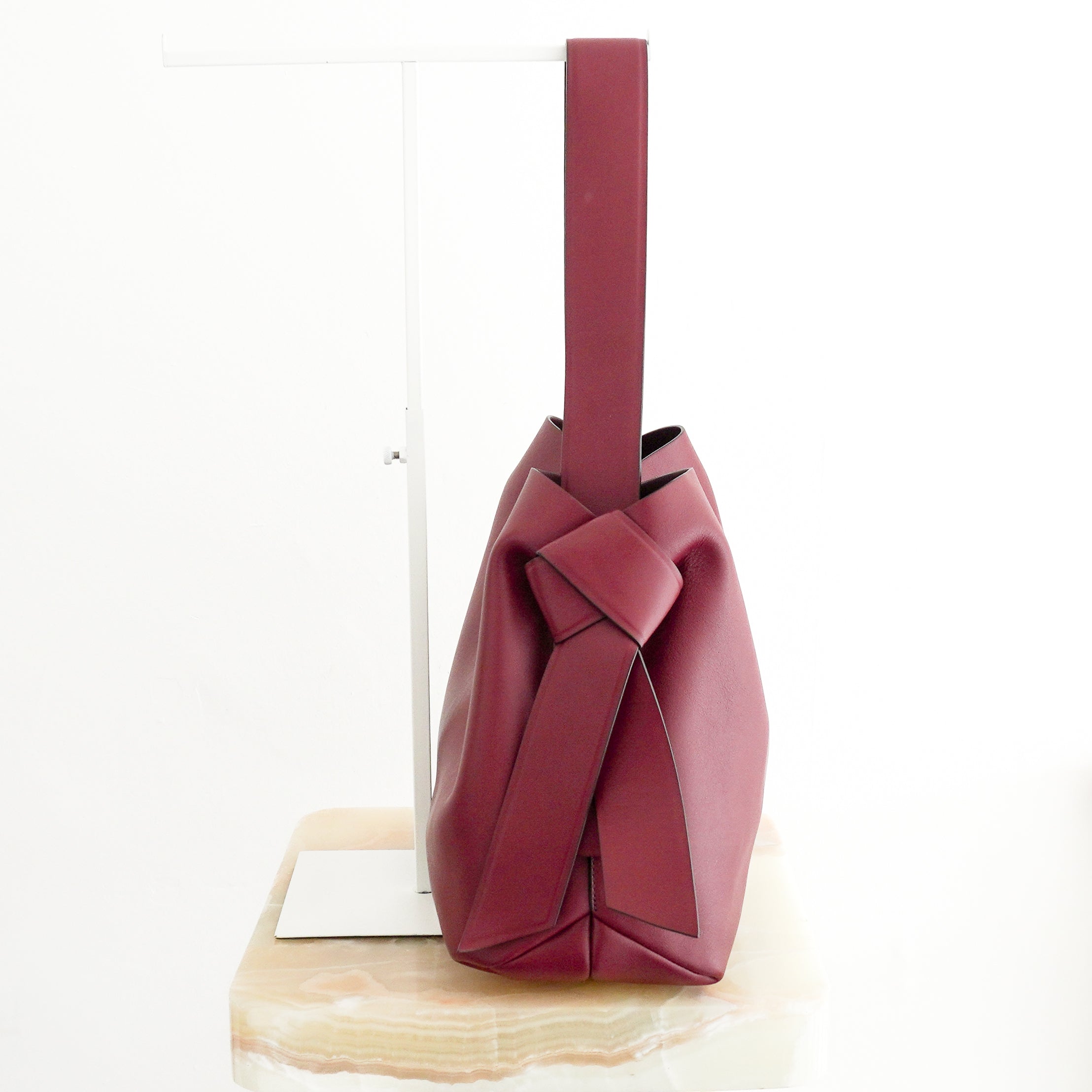 Acne Studios Medium Musubi Leather Tote Bag in Burgundy side photo chelsea london