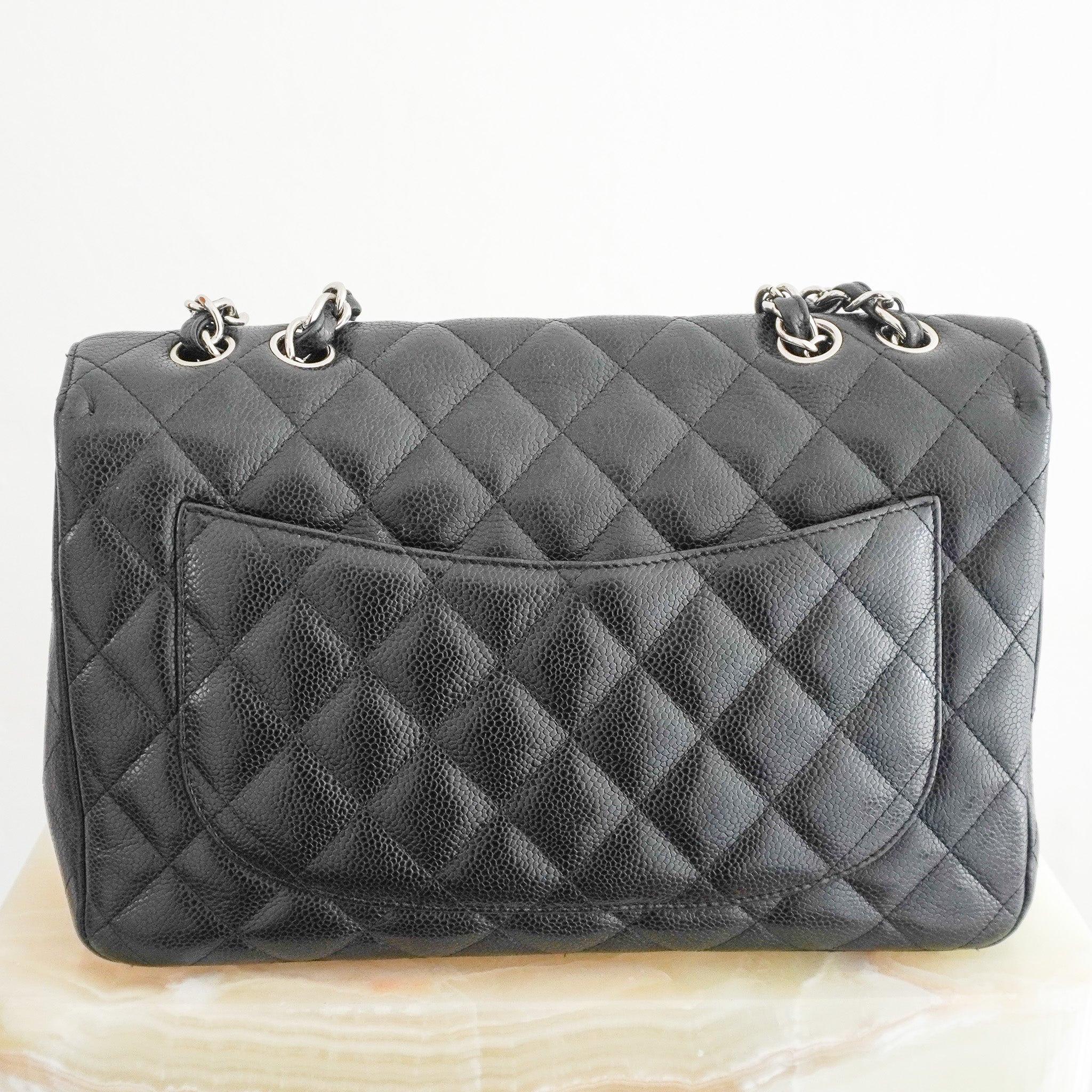 Back image of the Chanel Jumbo Classic Single Flap Bag in Black Caviar Leather