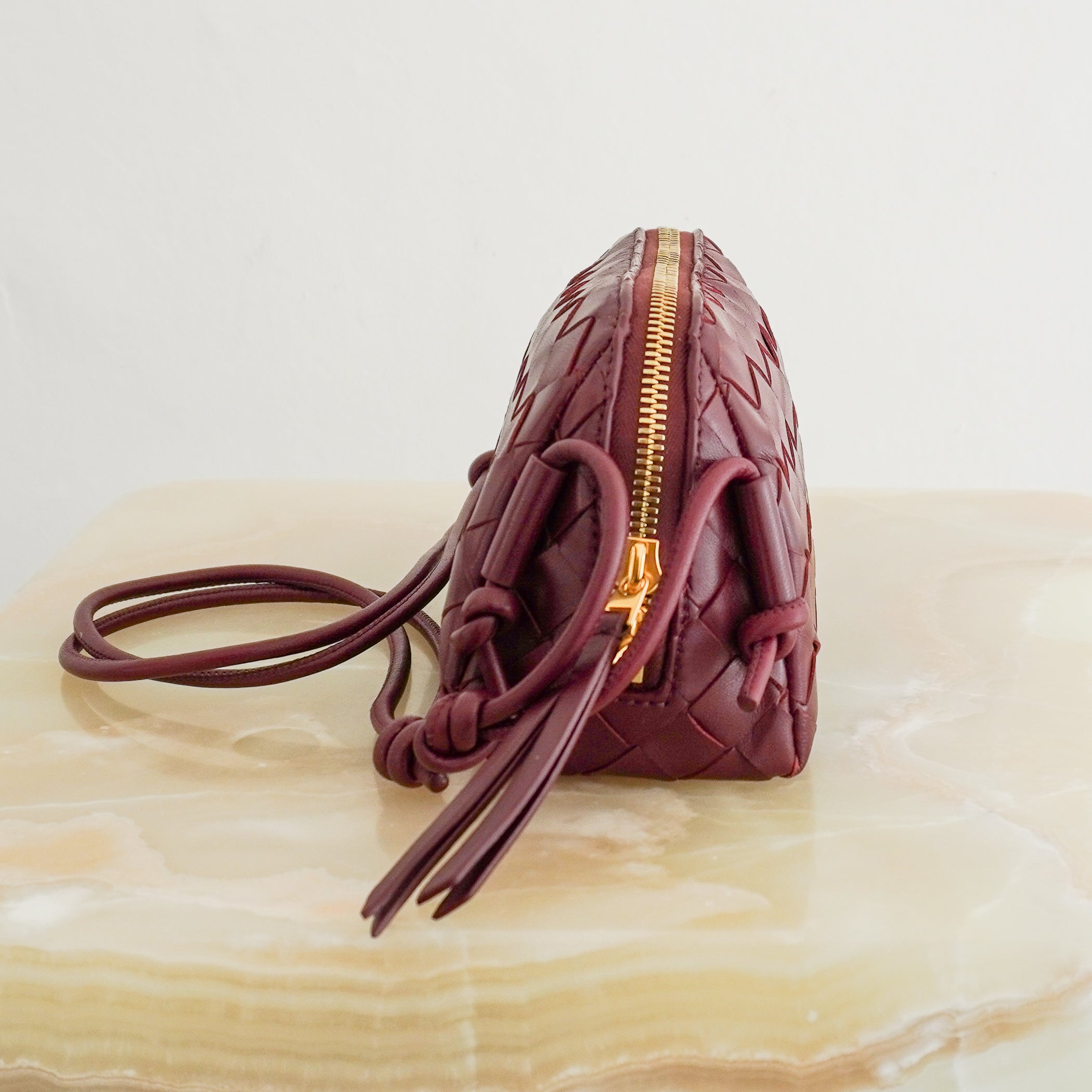 Bottega Veneta Intrecciato Concert Crossbody Bag Burgundy Leather side photo chelsea london