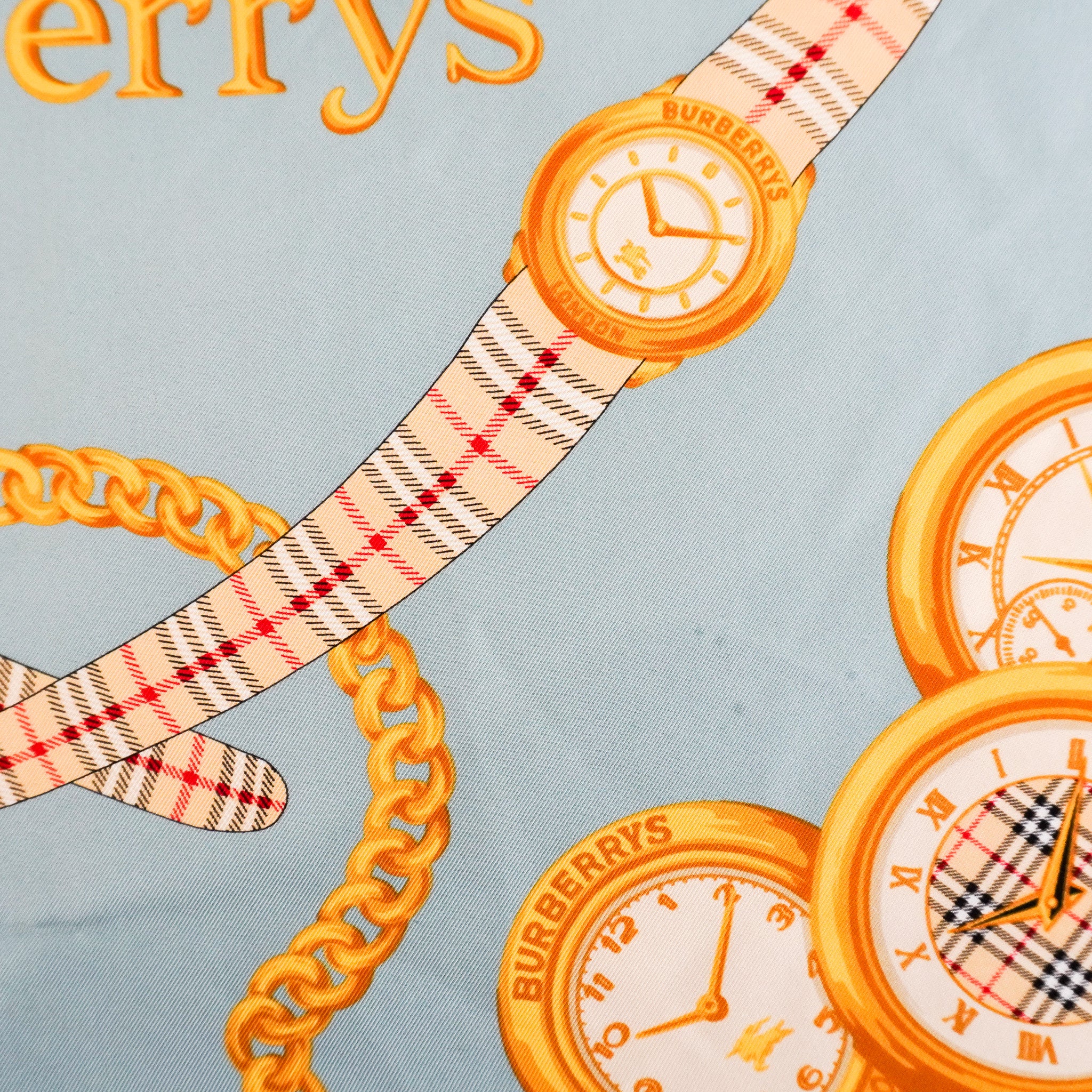 Burberry-Printed-Blue-And-Gold-Silk-Scarf-close-up