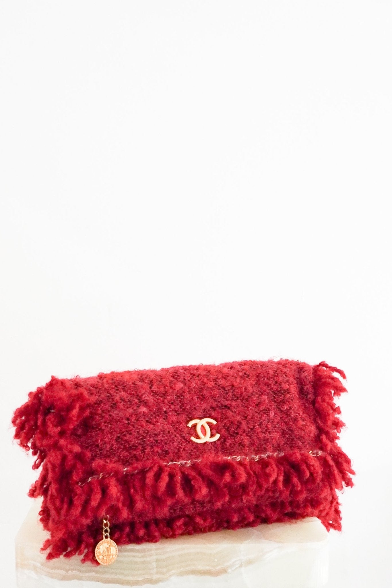 Front view of the Chanel Tweed Fringe Clutch in dark red, featuring a bifold design and Karl Lagerfeld era styling.