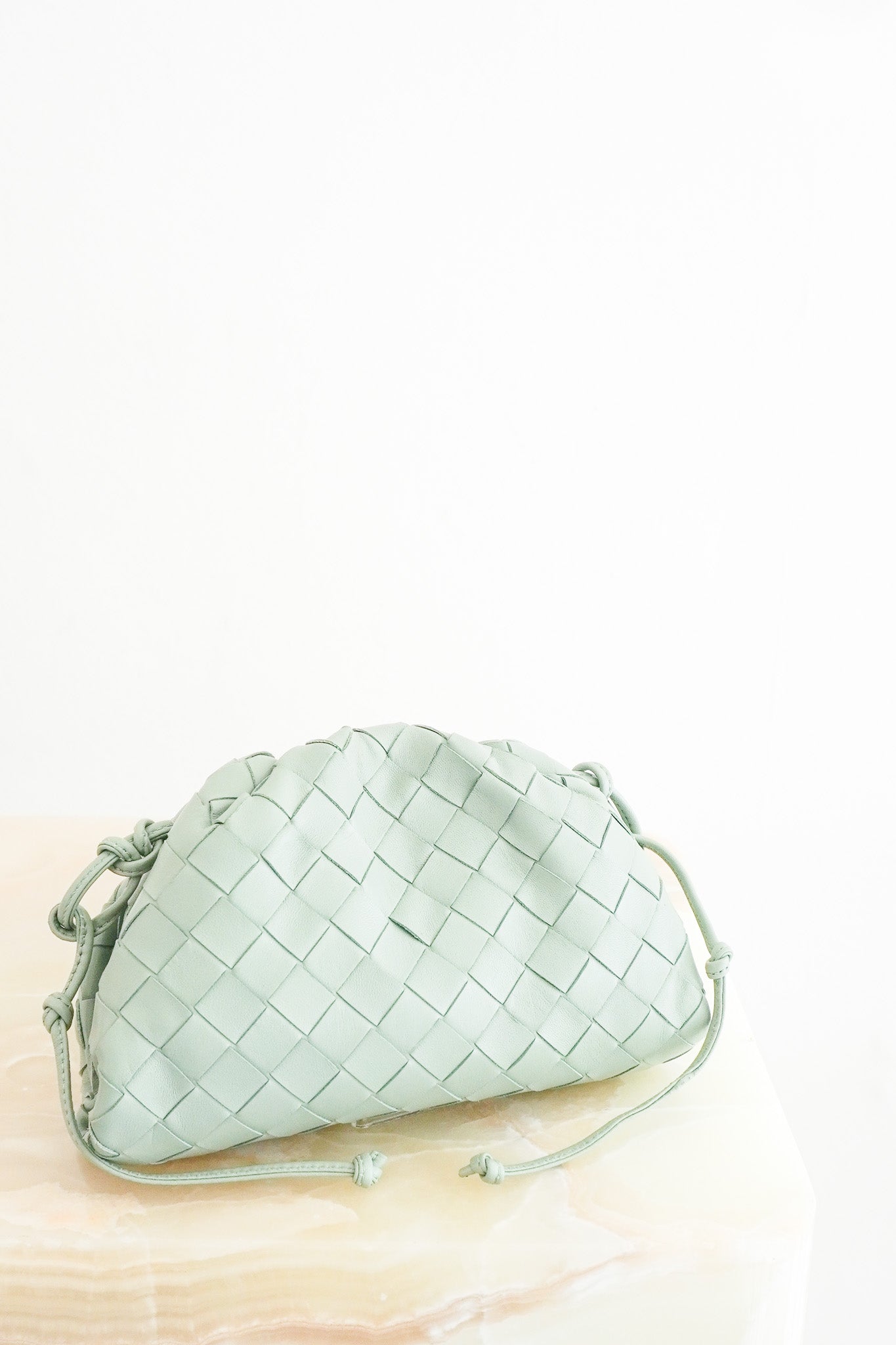 Front image of the Bottega Veneta Mini Intrecciato Pouch Crossbody Bag in Seafoam Green Leather Chelsea London