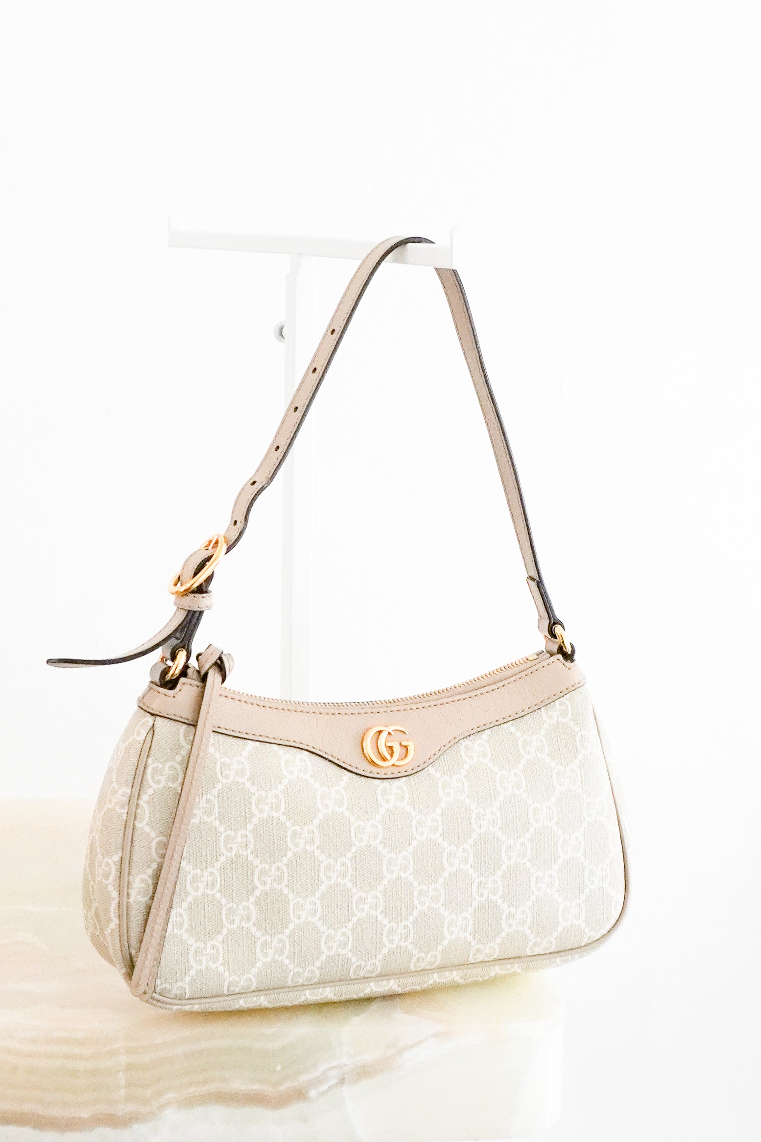 Authentic Gucci Ophidia Small Shoulder Bag in beige and ivory GG Supreme canvas with beige leather trim, gold-tone Double G logo hardware, adjustable shoulder strap and zip-top closure.