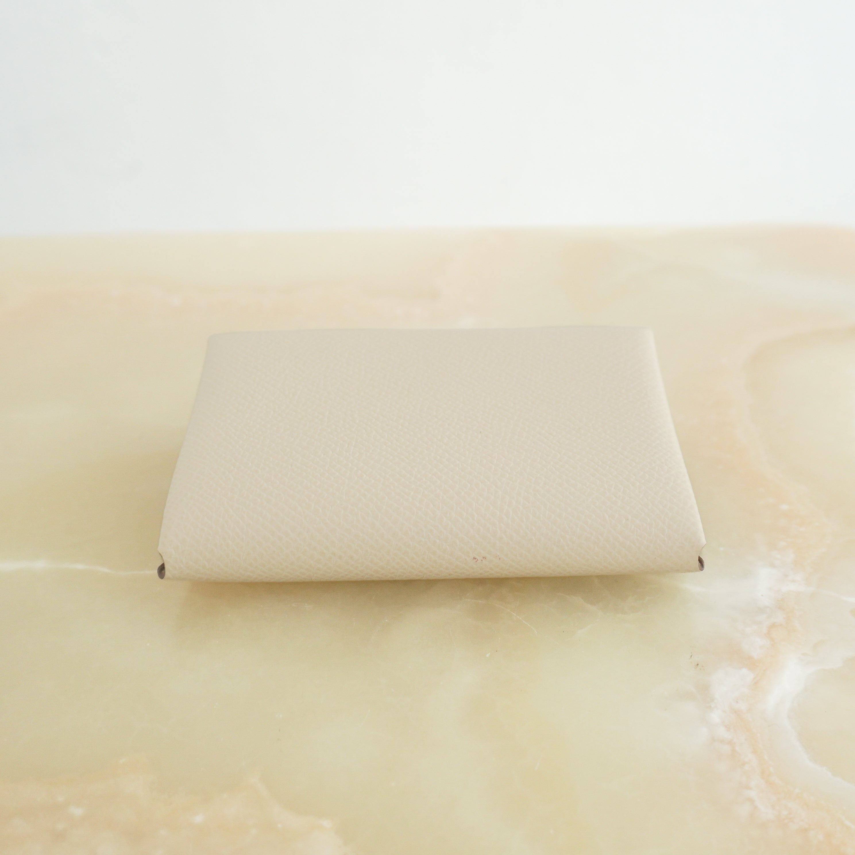 Hermès Calvi Card Holder in Cream Epsom Leather top photo chelsea london