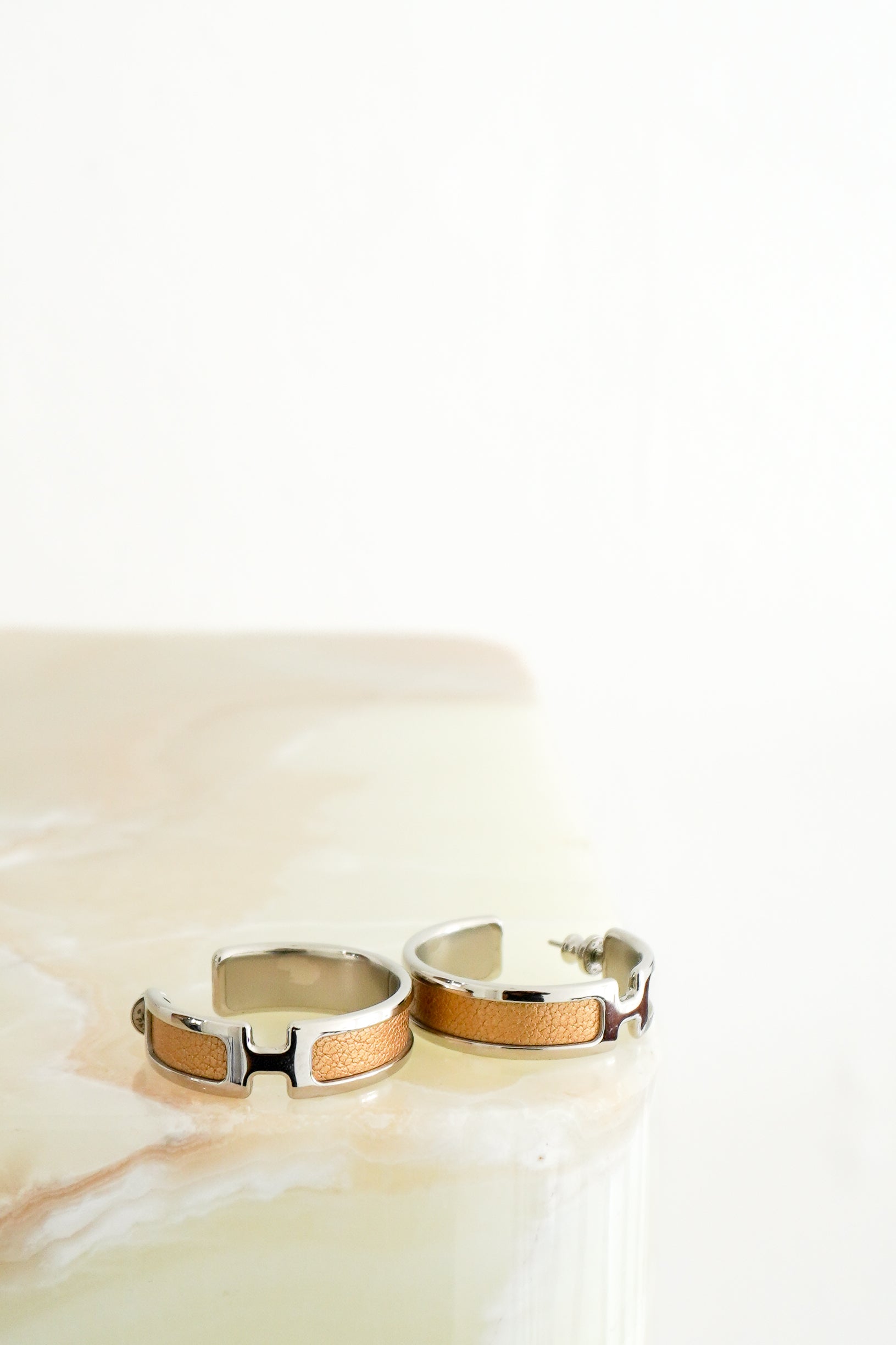 Hermès Olympe Earrings in Palladium-Plated Metal & Doré Metallic Leather front photo chelsea london
