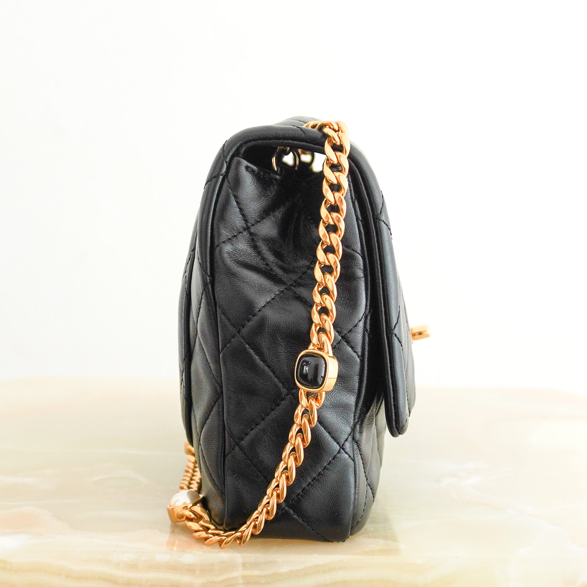 Side image of the Chanel Black Lambskin Quilted Flap Bag with Bijoux Chain