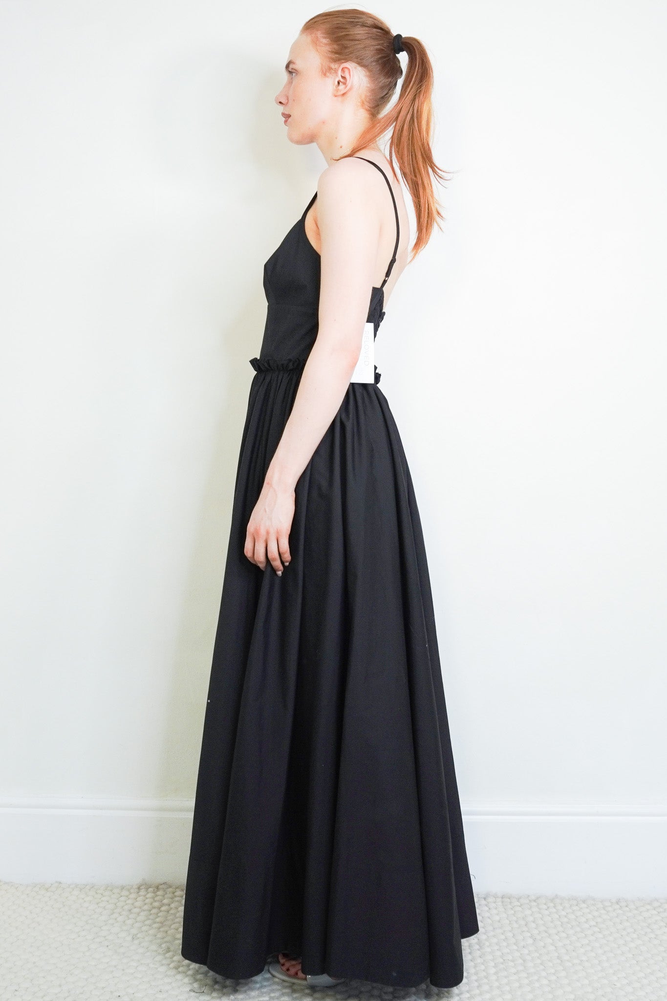 Side image of the Goop. Black Dress
