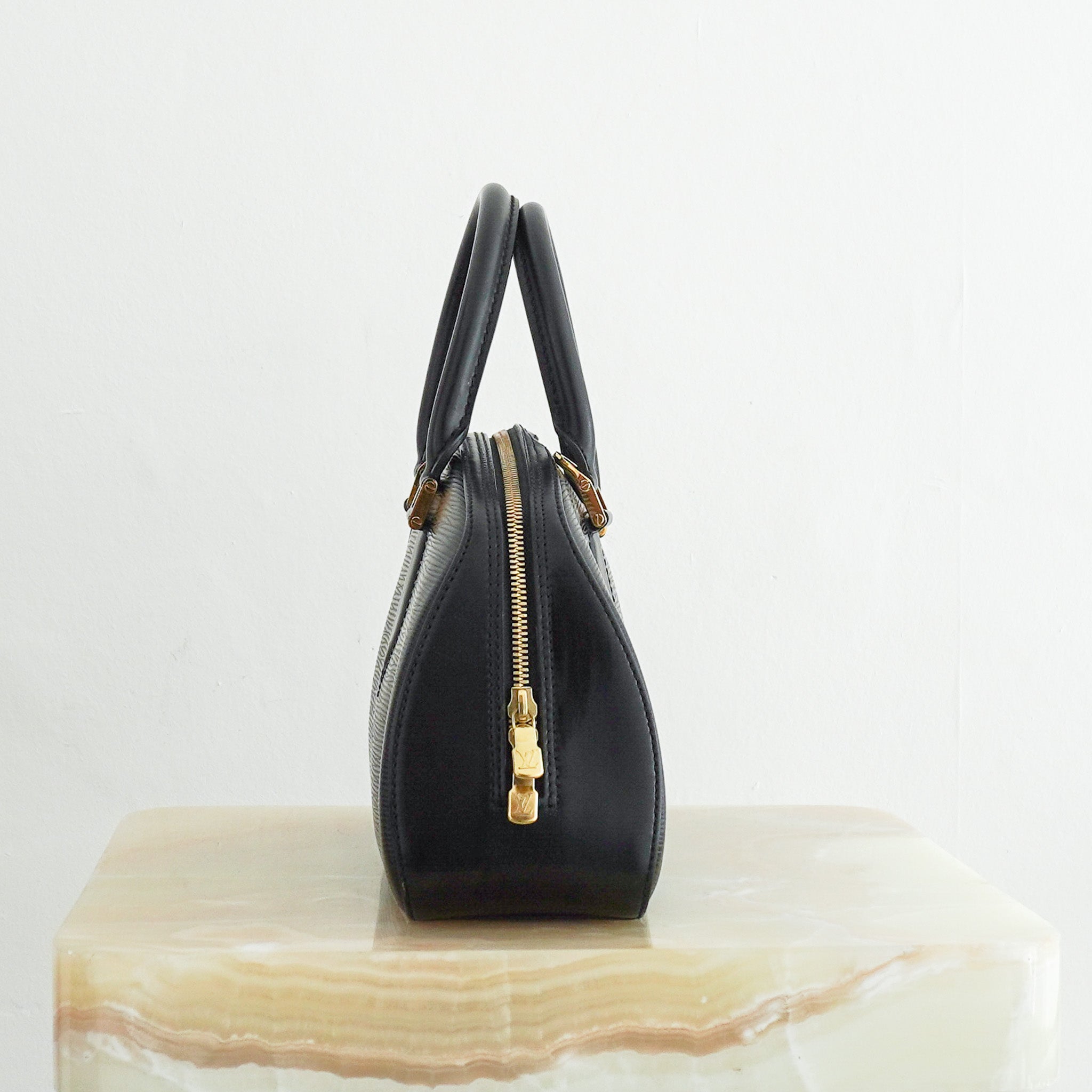 Side image of the Louis Vuitton Black Epi Jasmine Handbag