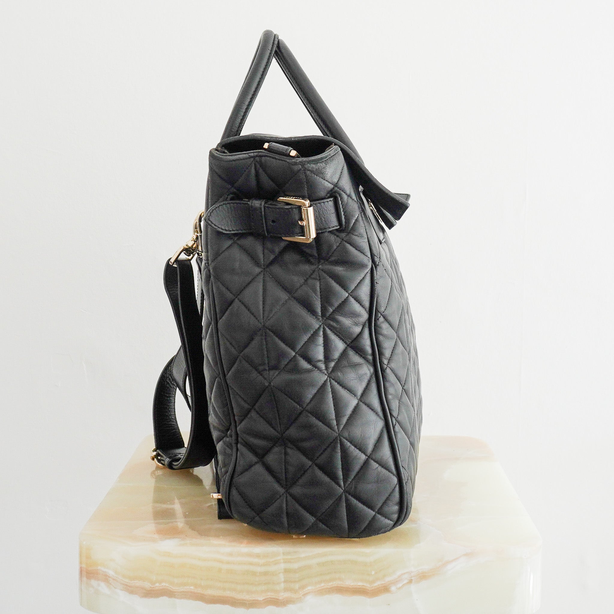 Side image of the Mulberry Black Cara Delevigne Quilted Leather Backpack