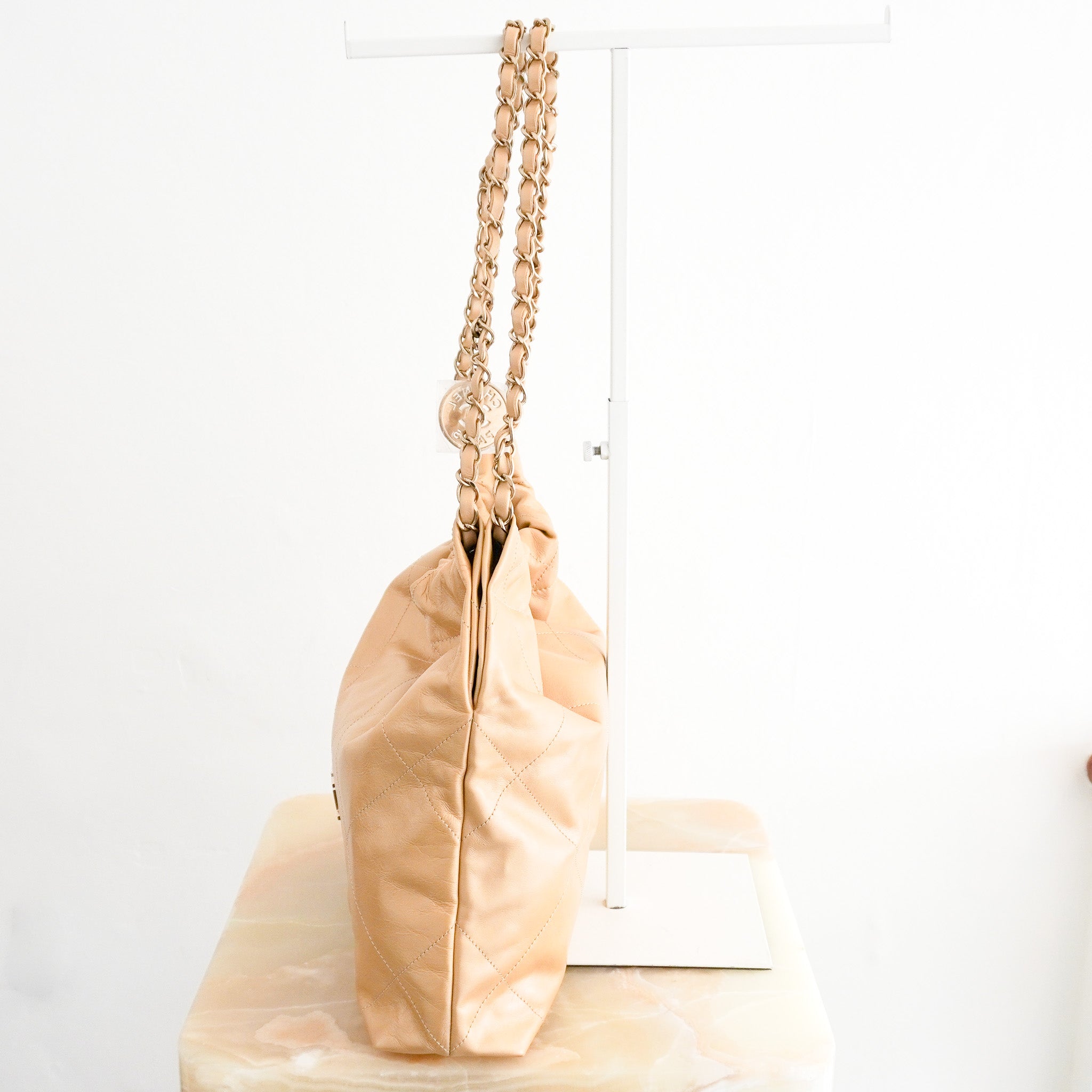 Side image of the NEW Chanel 22 Small Hobo Bag in Gold Shiny Calfskin
