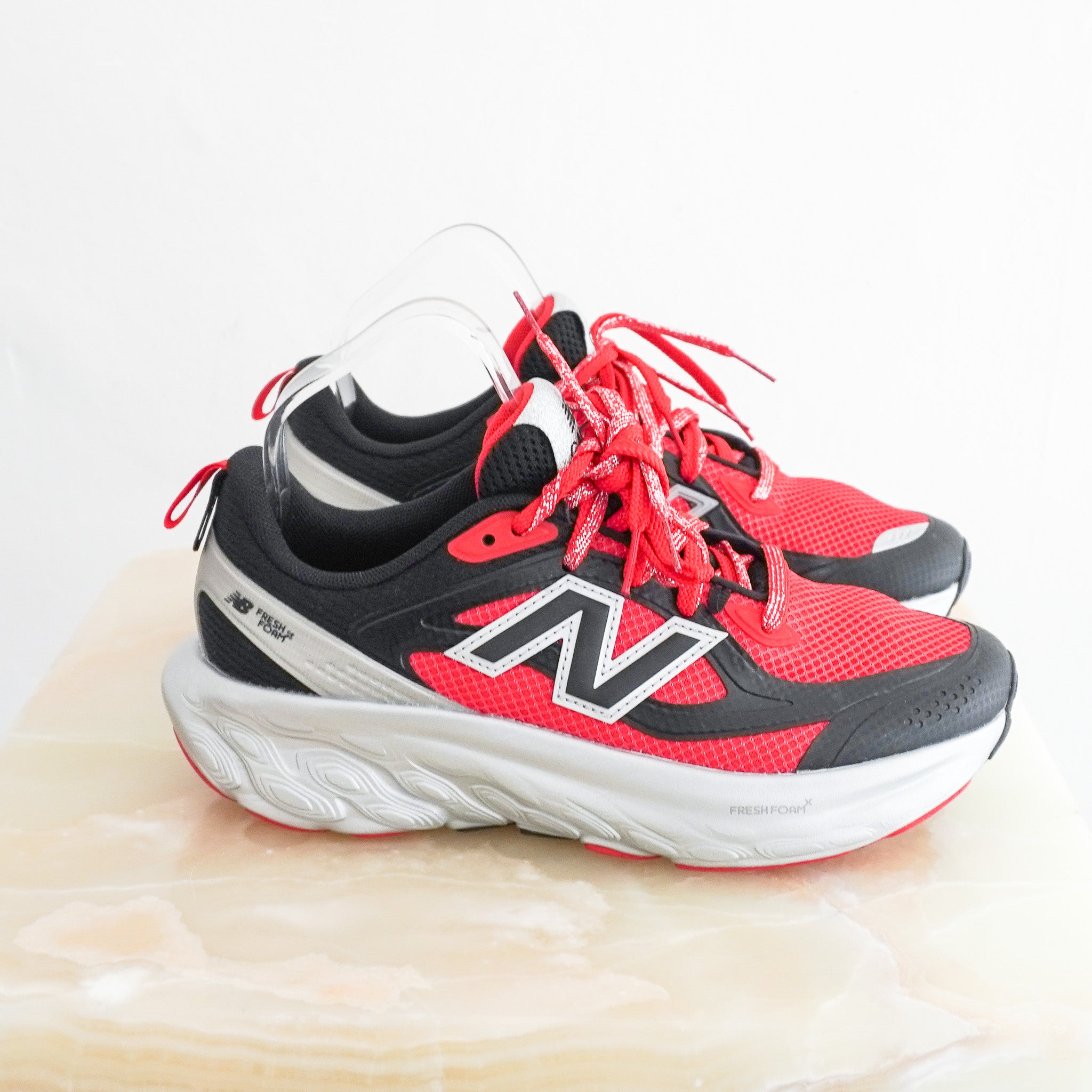 Side photo of the Ganni X New Balance Trainers in Red