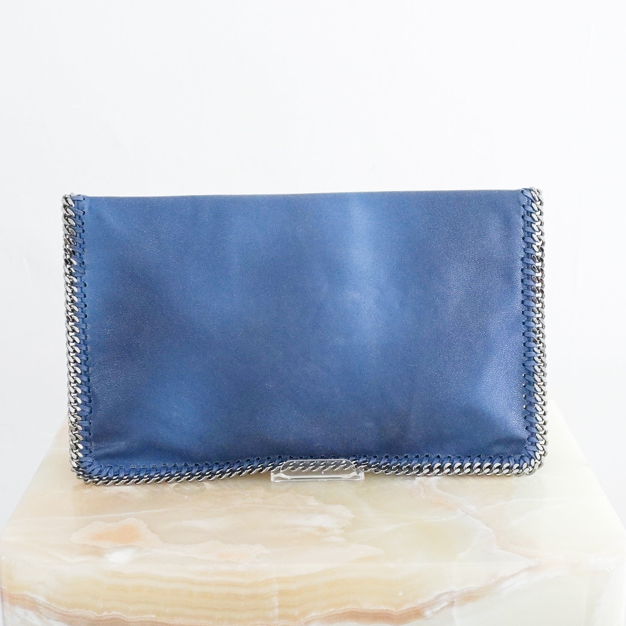 Back photo of Stella McCartney Blue Falabella Clutch Bag in faux leather featuring the signature silver chain trim and whipstitch detailing.