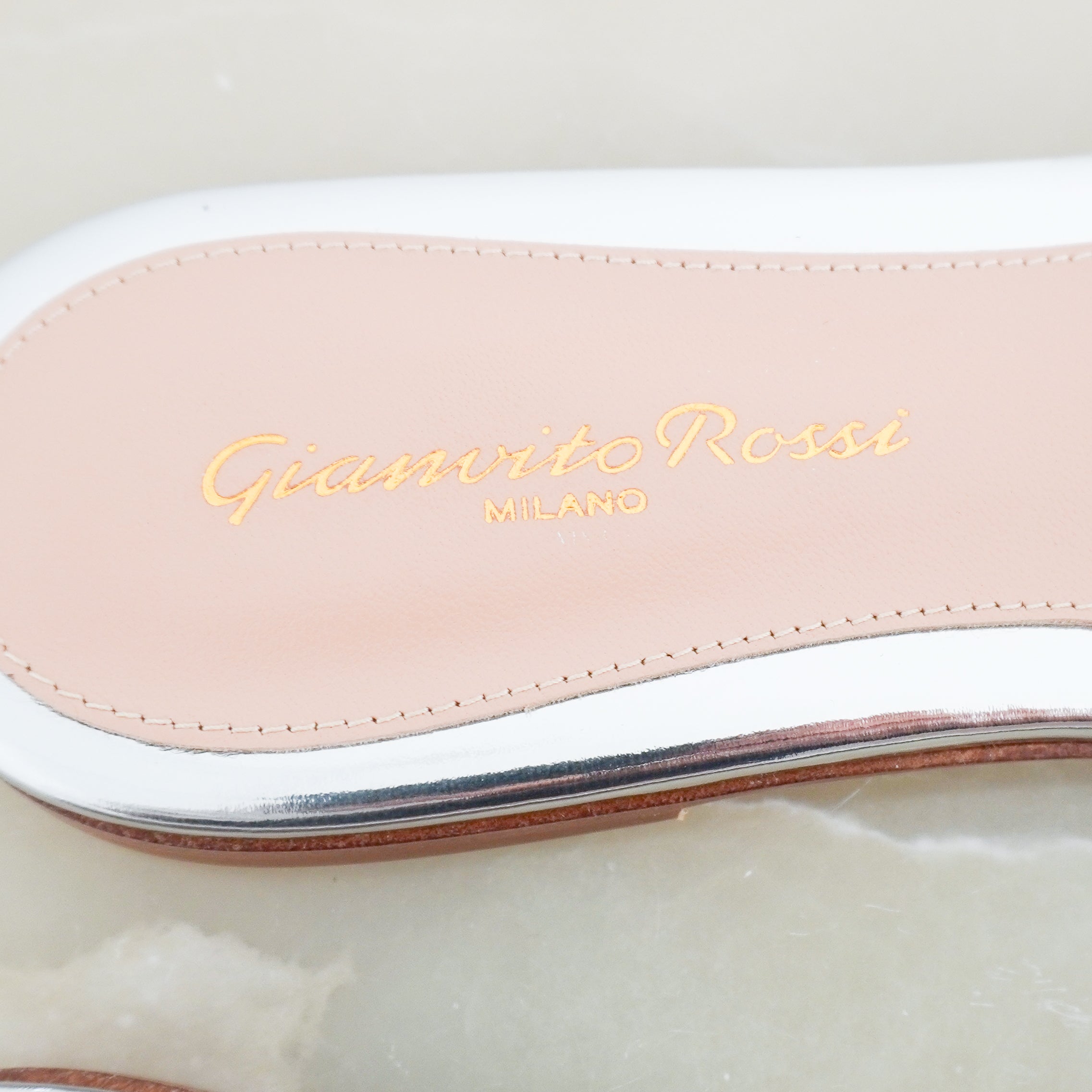 Logo image of the Gianvito Rossi mules, showing the Gianvito Rossi name in gold.