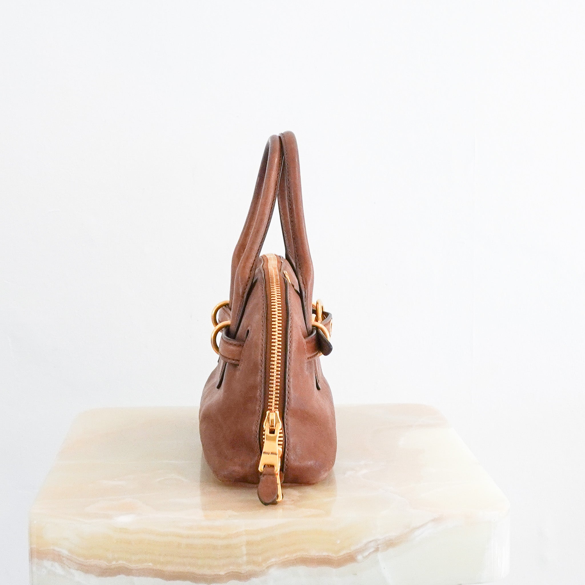 side photo of the Miu Miu Adventure Nappa Leather Top Handle Bag in Oak