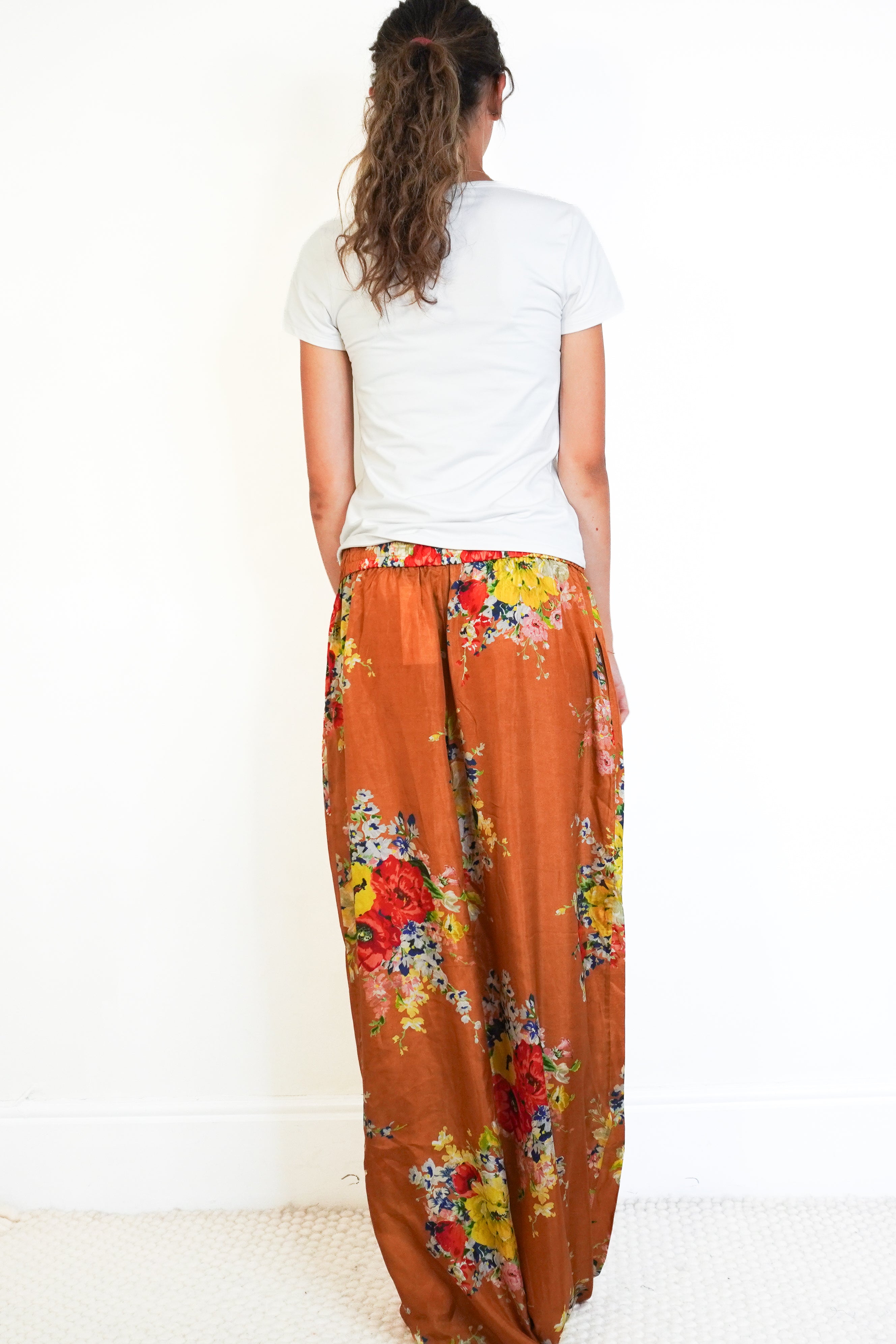 Back picture of the orange floral zimmermann trousers