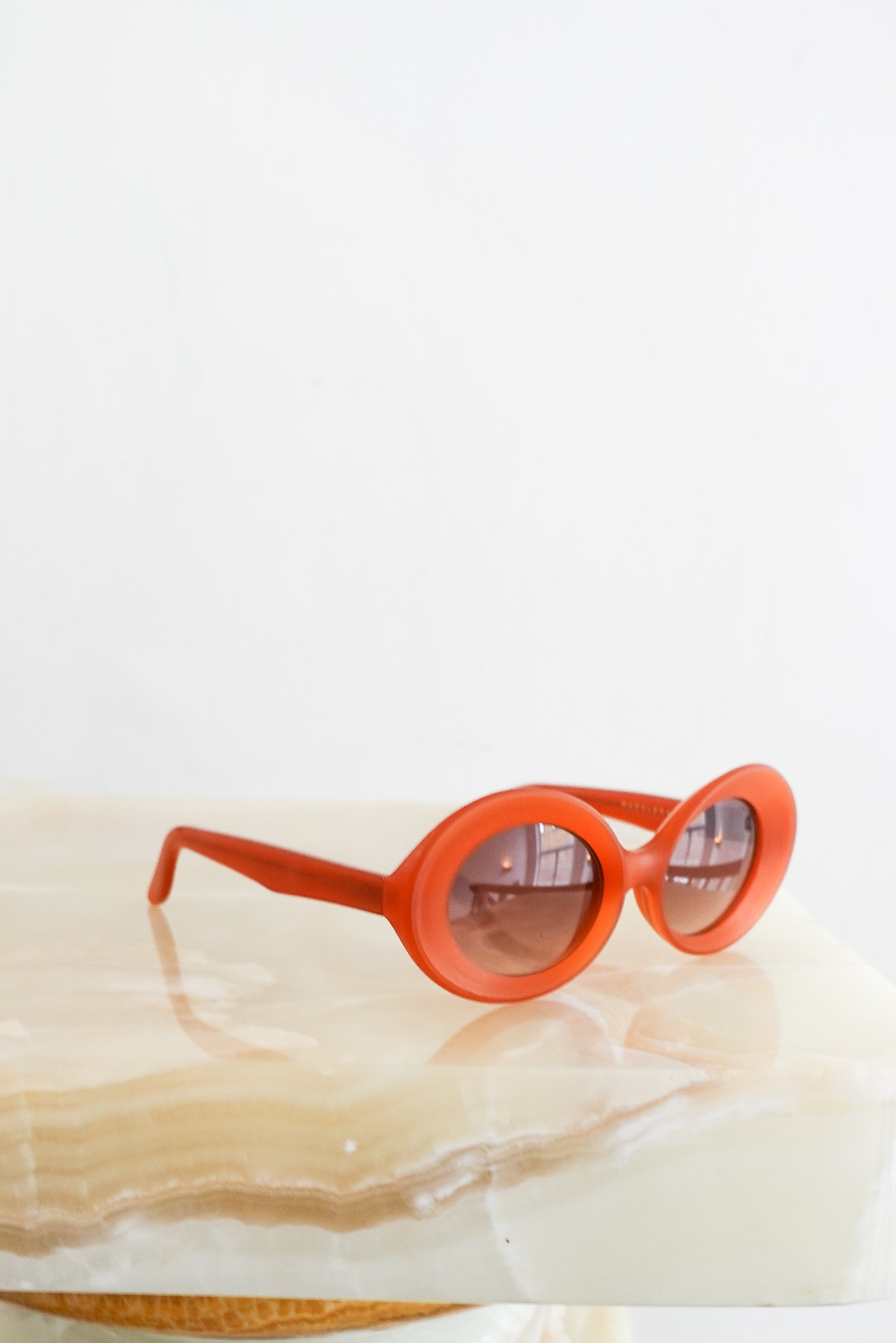 Orange oval sunglasses RRP £395