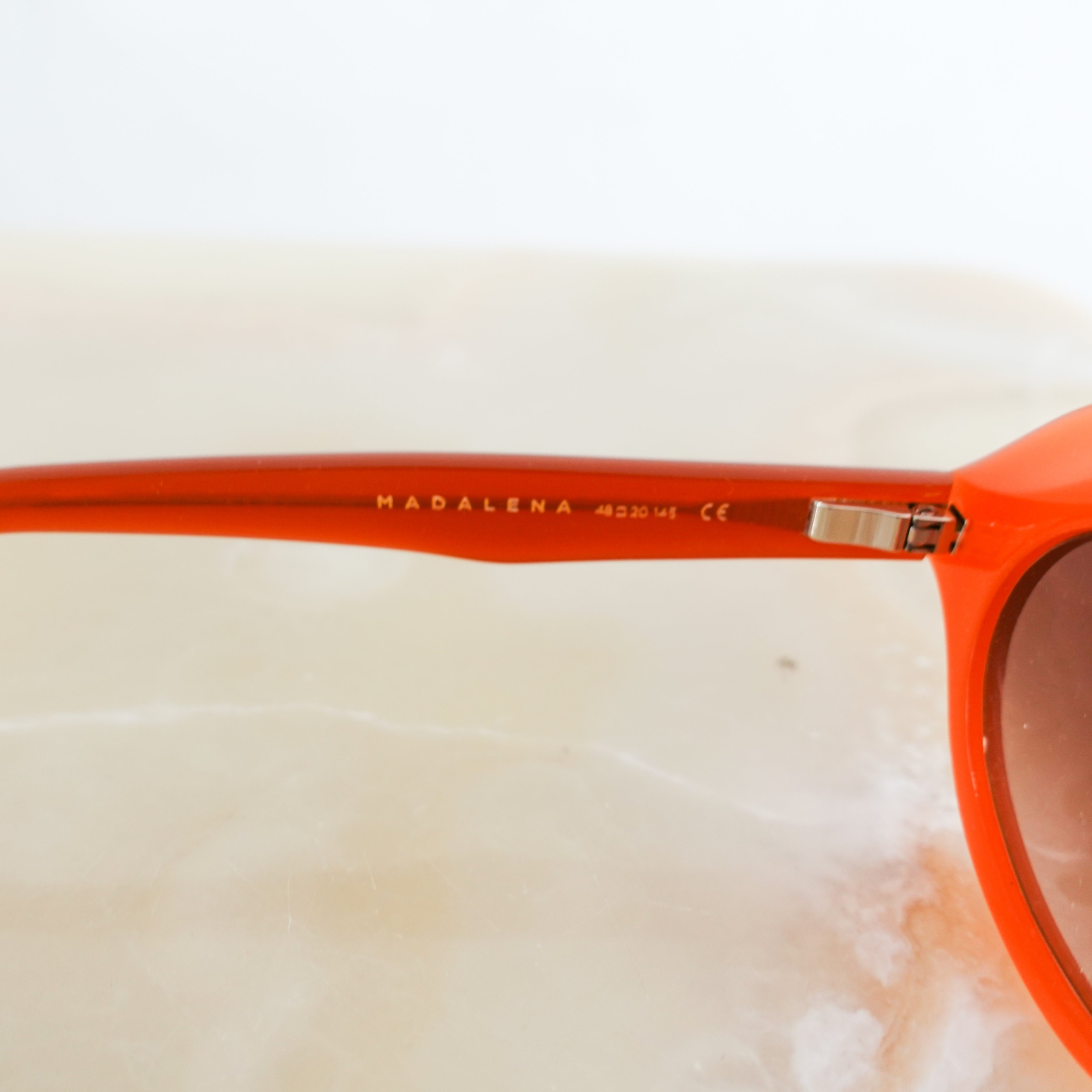 Orange oval sunglasses RRP £395