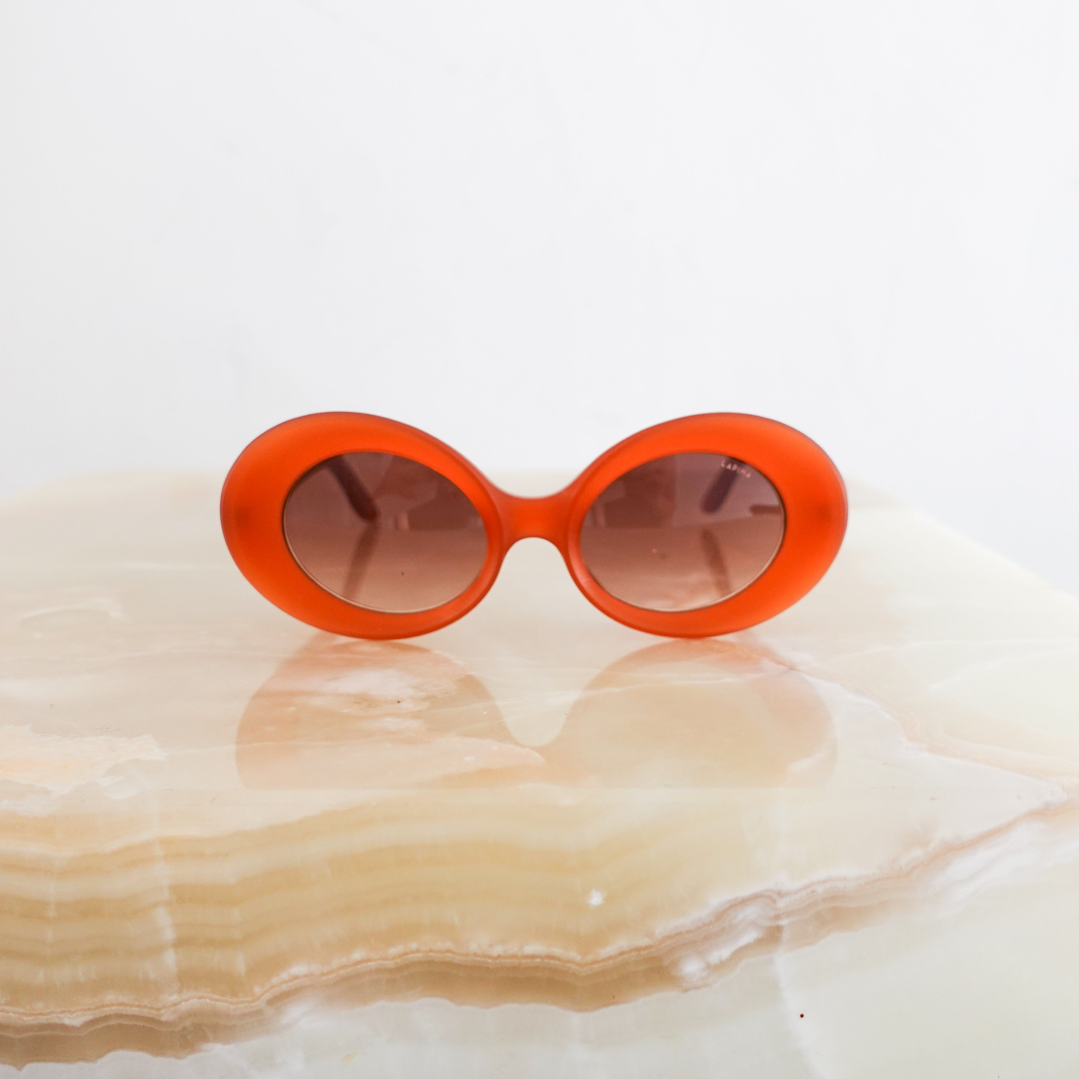 Orange oval sunglasses RRP £395