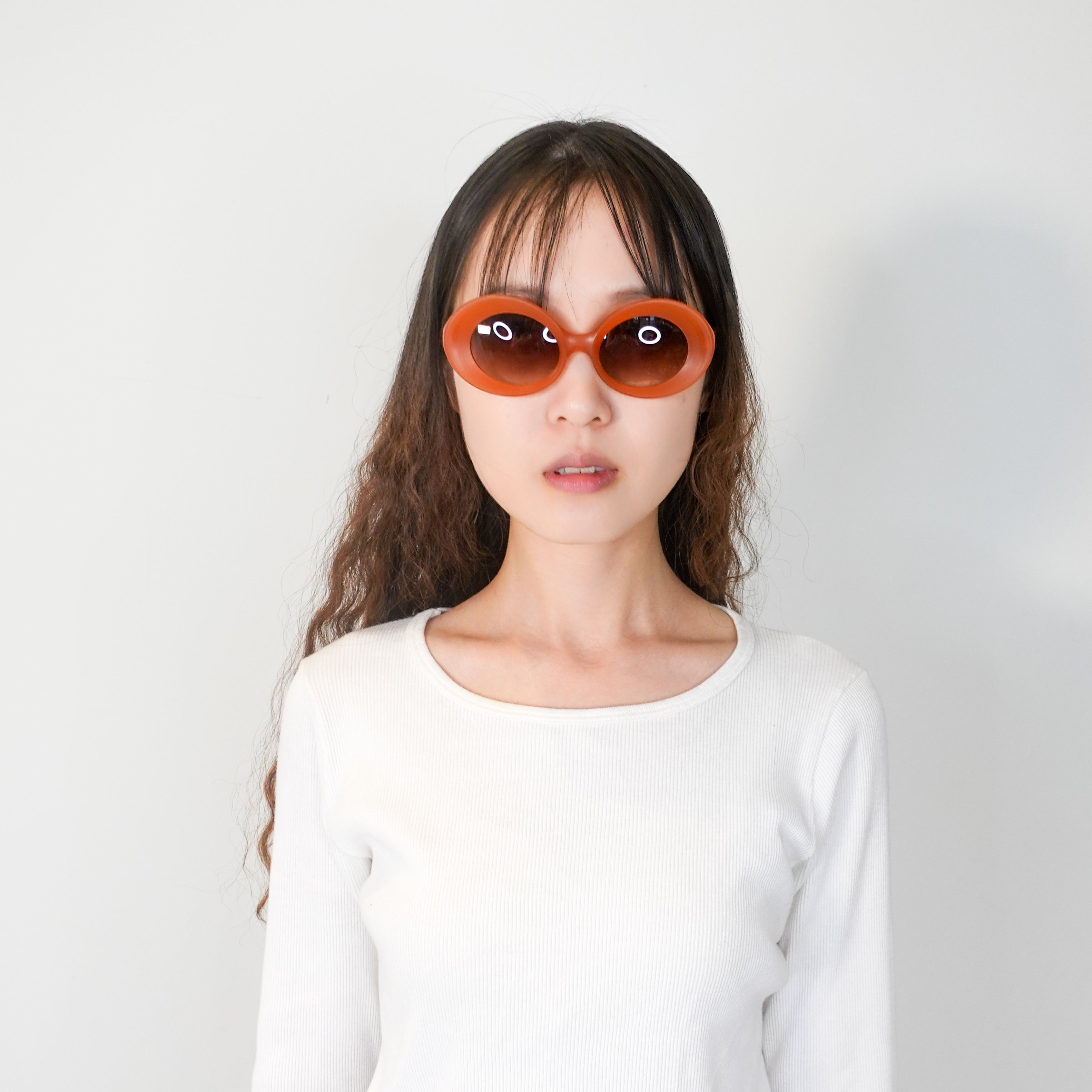 Orange oval sunglasses RRP £395