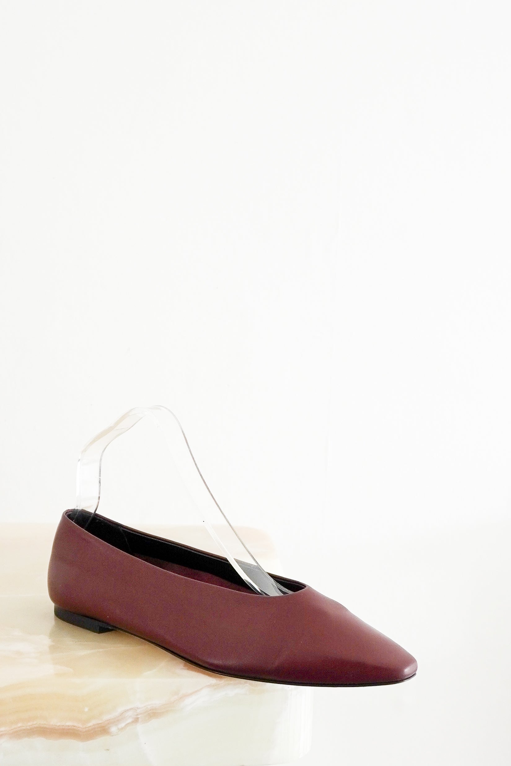 Front view photo of a single Aeyde Burgundy Betty Ballet Flat, showcasing its smooth matte leather upper, high glove-like vamp, and tapered soft square toe