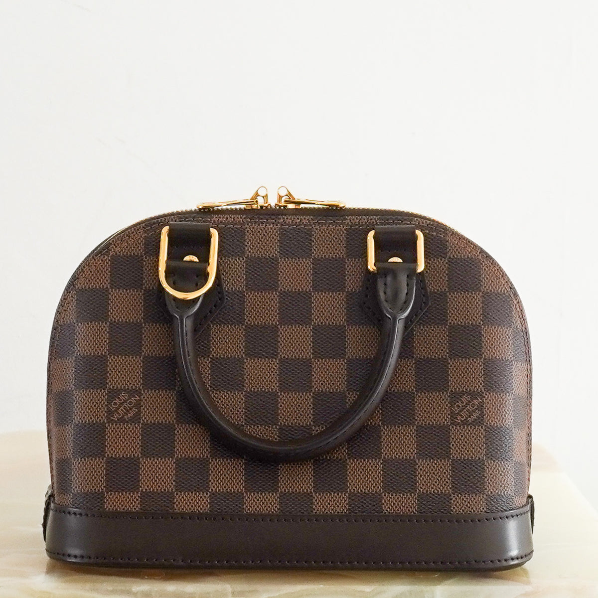 Back: Louis Vuitton Alma BB Bag in Damier Ebene Canvas