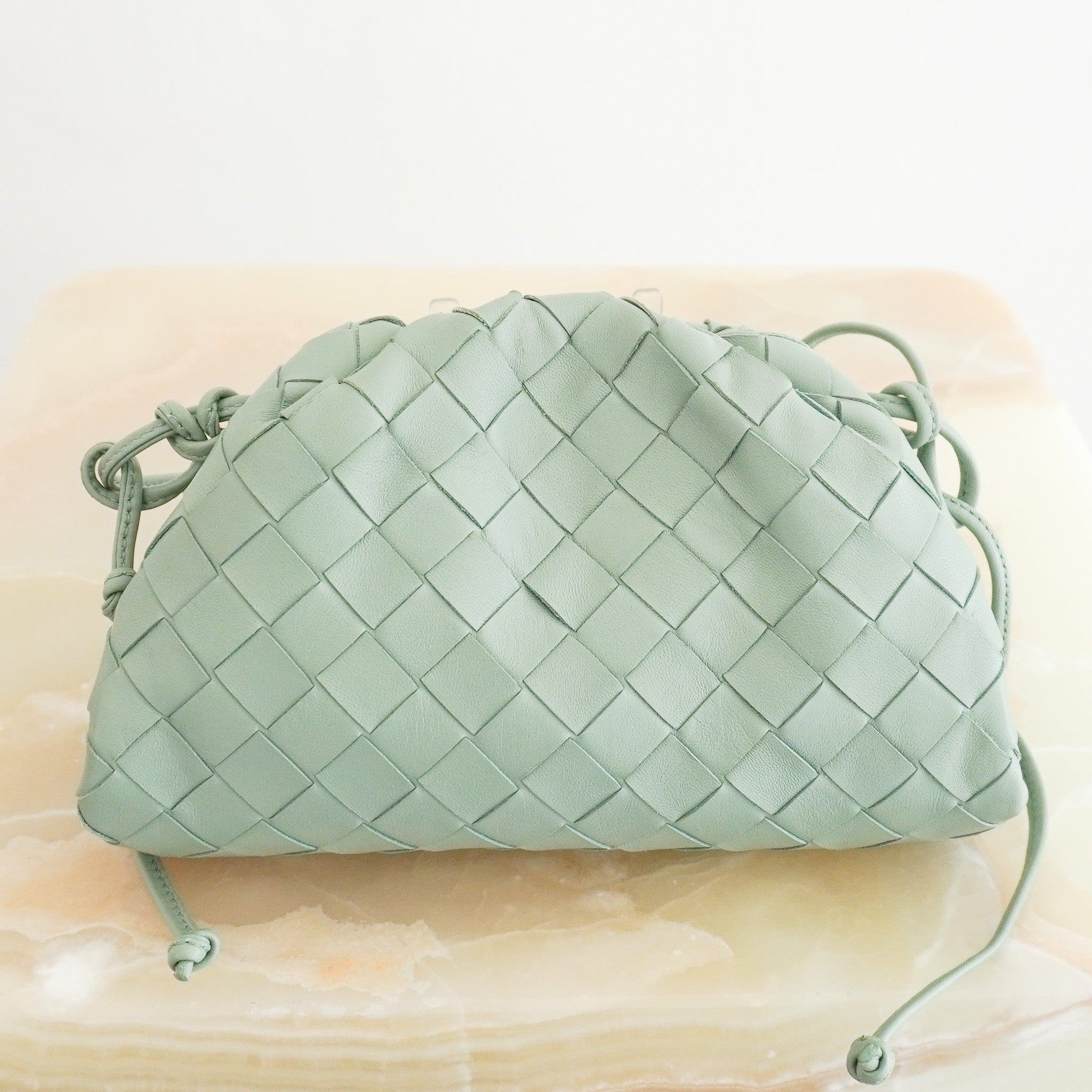 Back image of the Bottega Veneta Mini Intrecciato Pouch Crossbody Bag in Seafoam Green Leather 