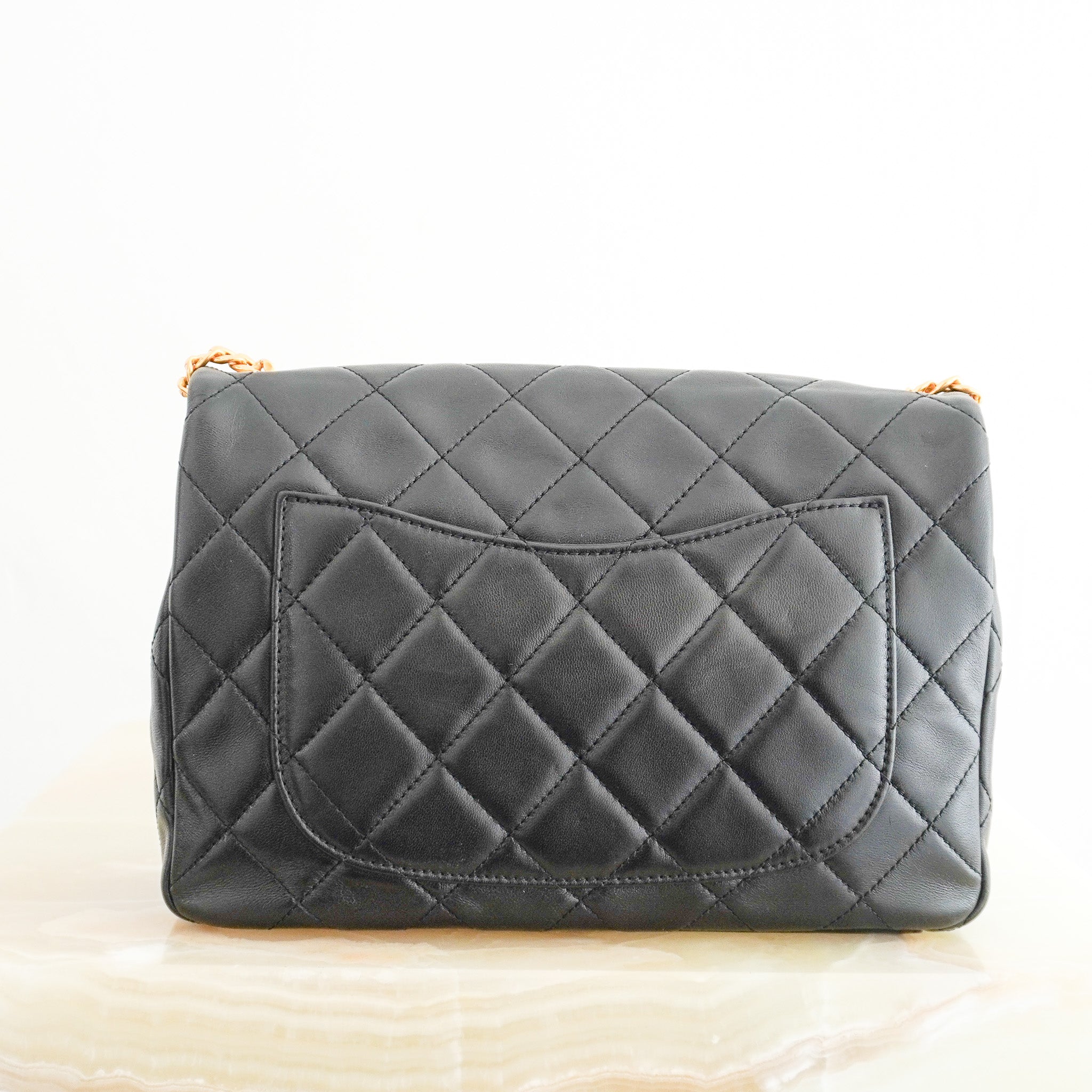 Back image of the Chanel Black Lambskin Quilted Flap Bag with Bijoux Chain 