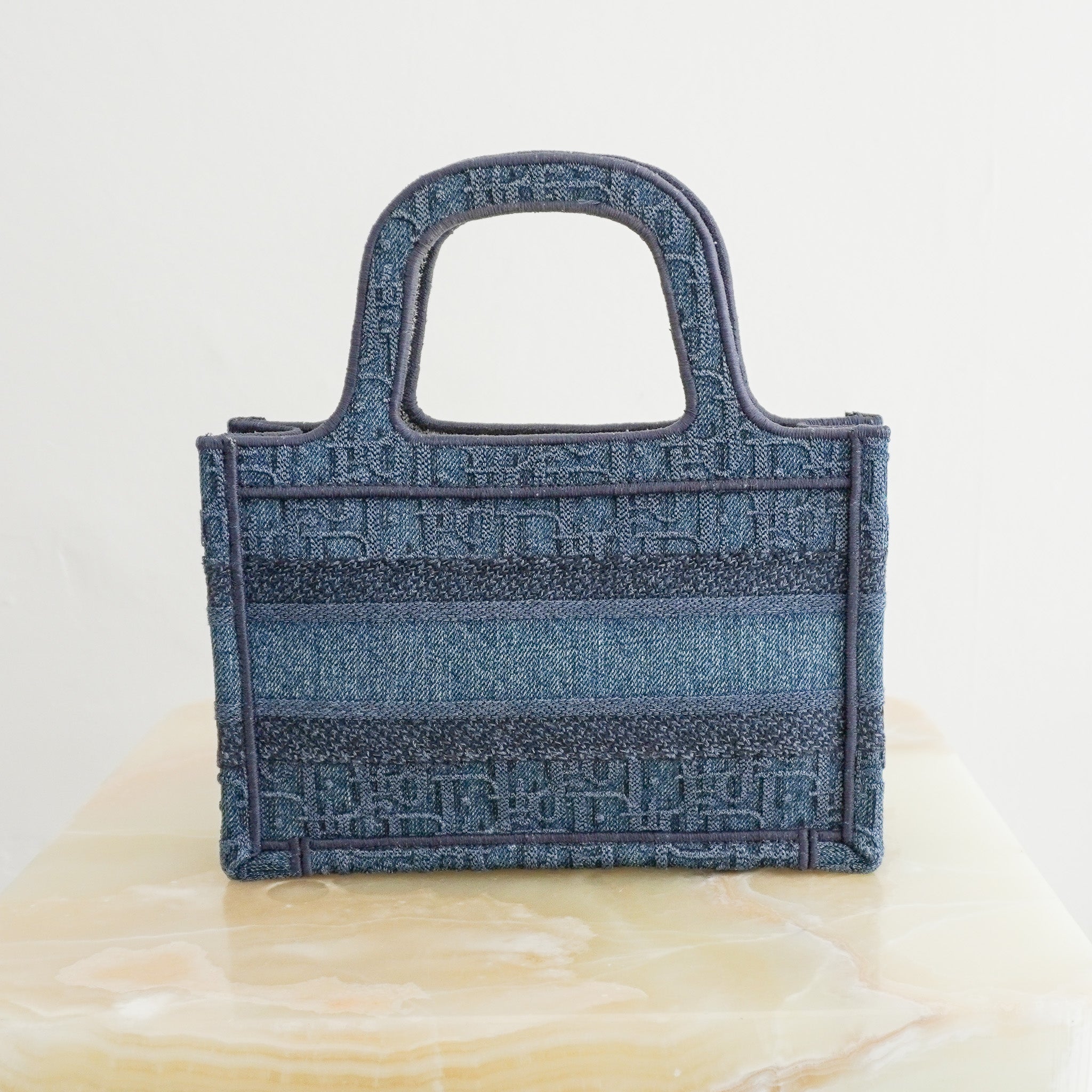 Back image of the Dior Oblique Embroidered Denim Mini Book Bag