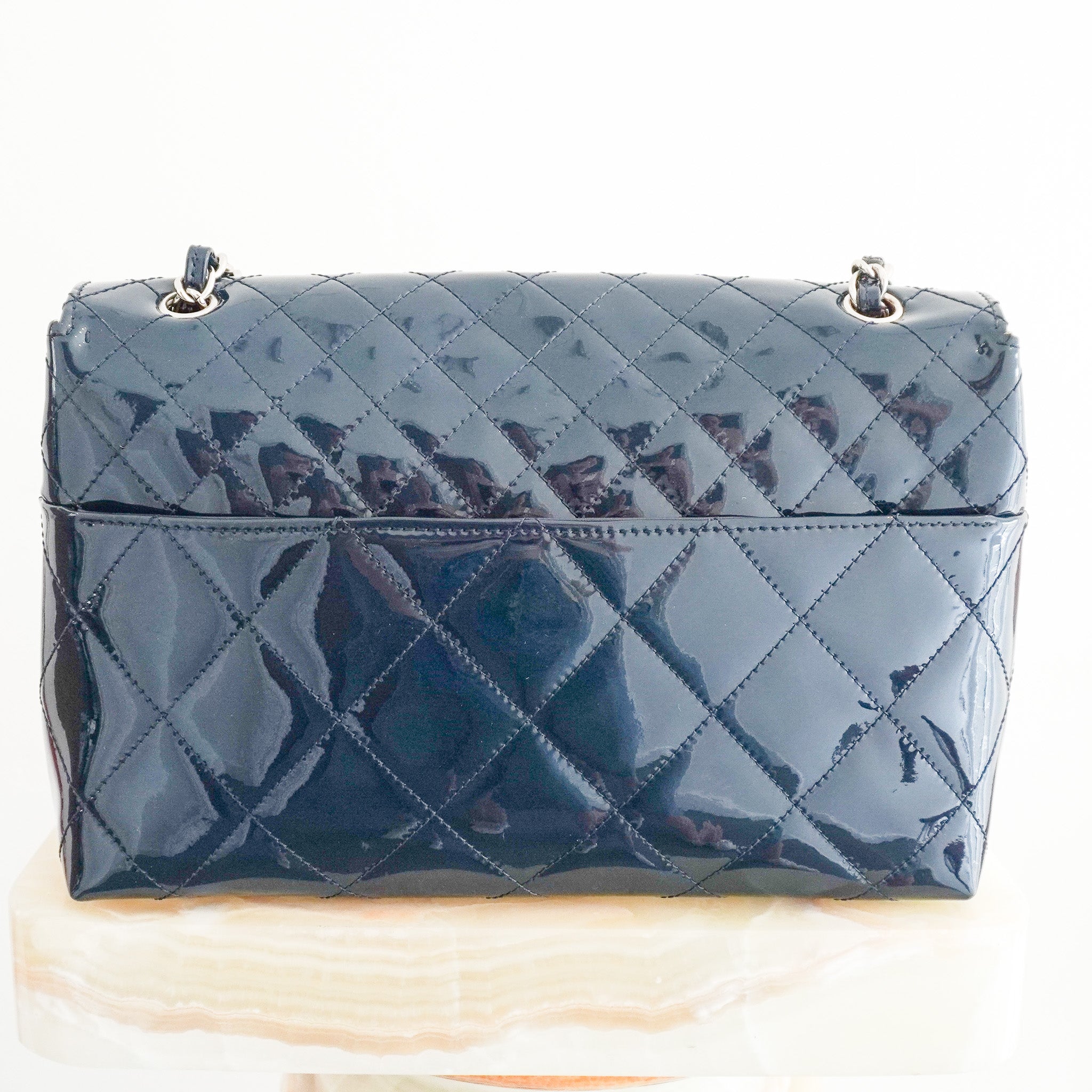 Back photo of the Chanel Jumbo Patent Leather Flap Bag in Navy
