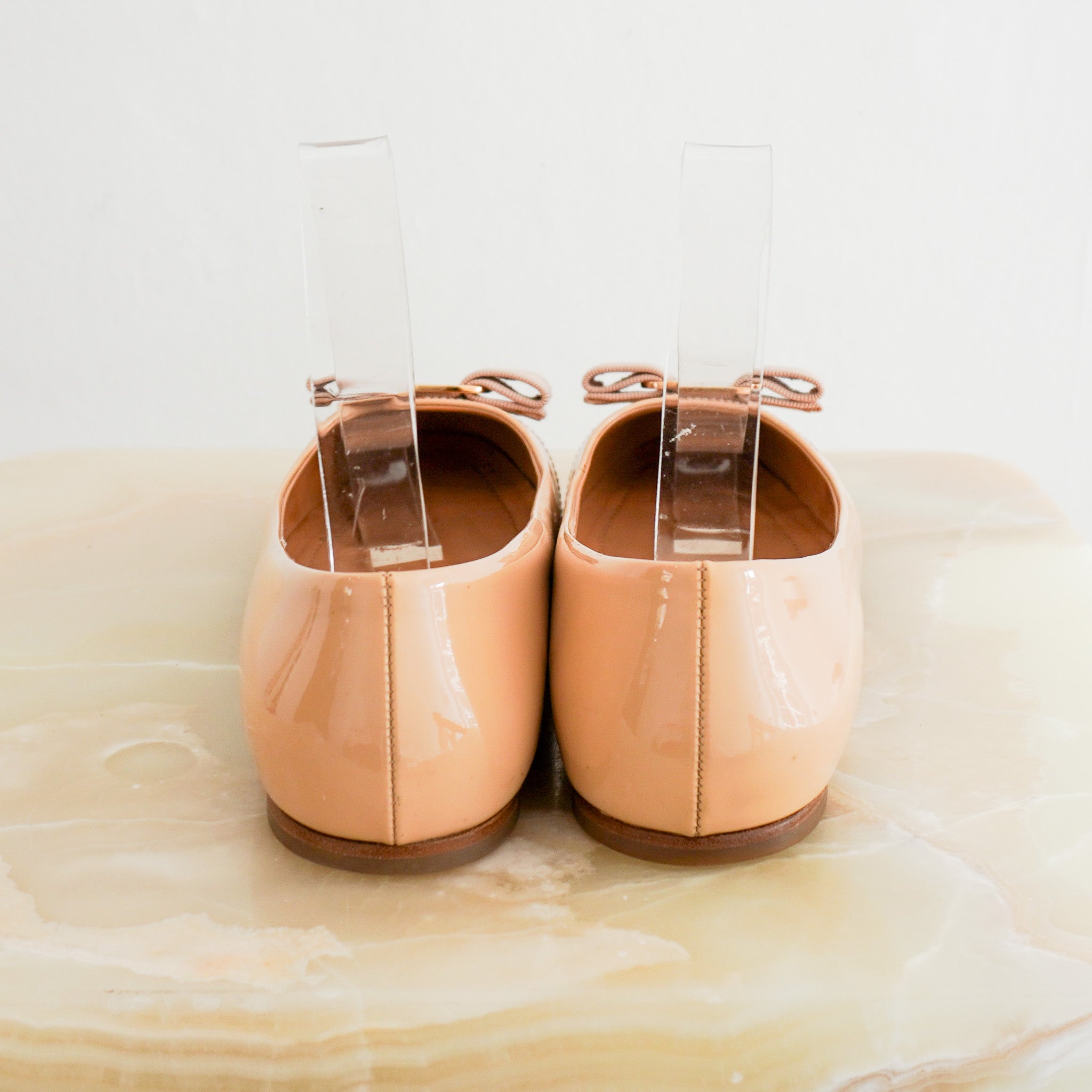 Back photo of the Ferragamo Tan Patent Bow Pumps