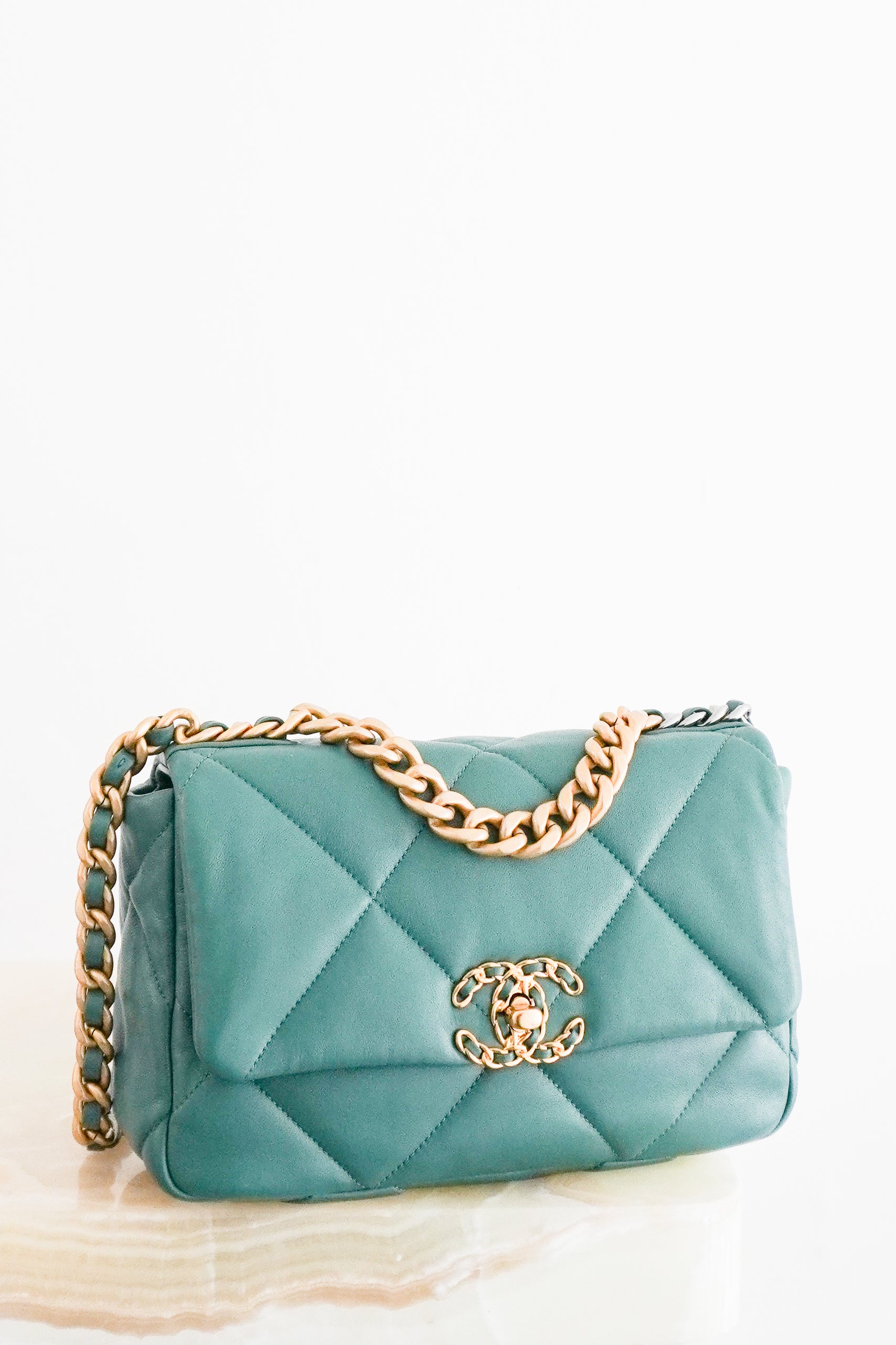 Front photo of a Chanel 19 Small Flap Bag crafted from supple aged calfskin leather with the collection's signature oversized diamond quilting.