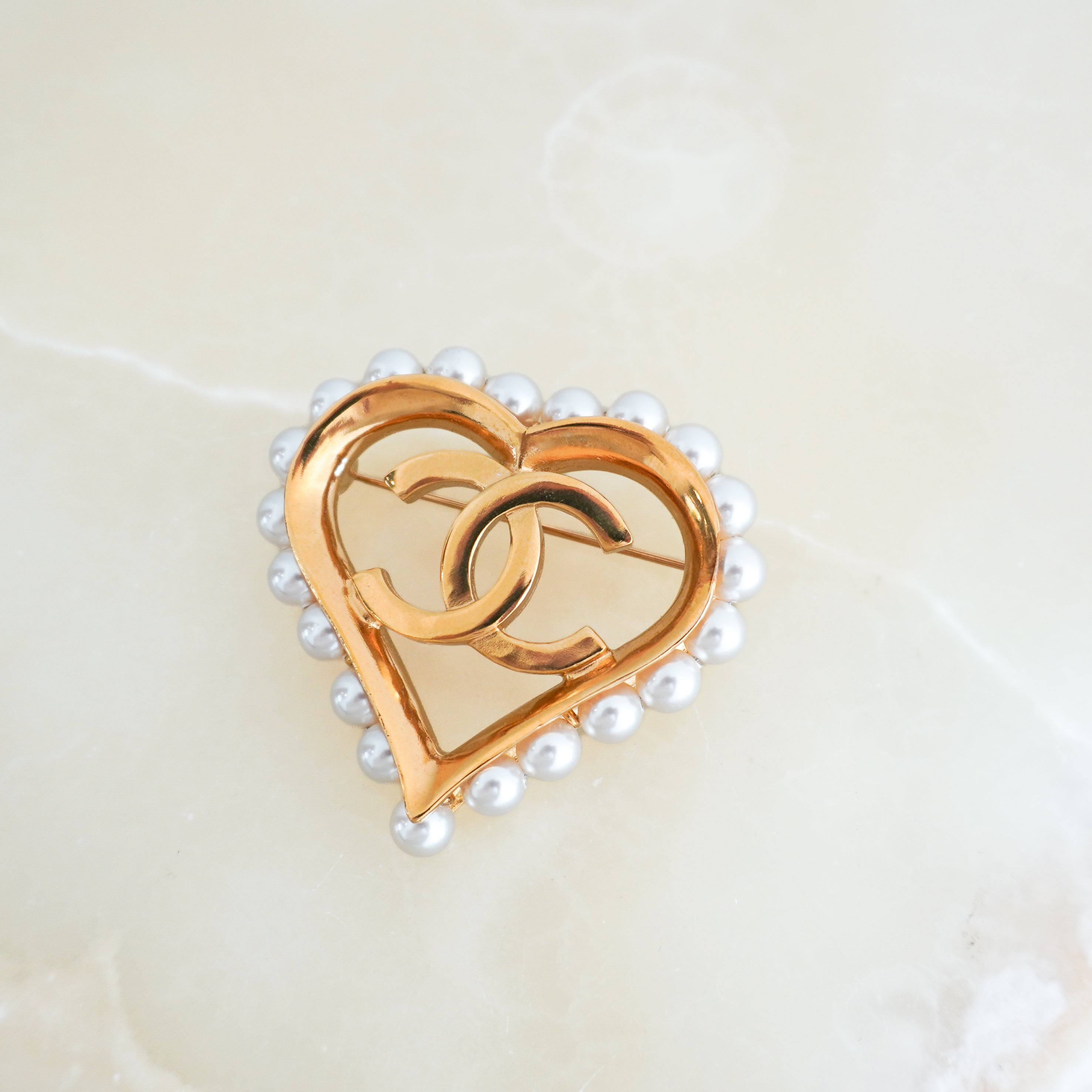 Chanel CC Heart Pearl Brooch in Gold-Tone Metal close photo chelsea london