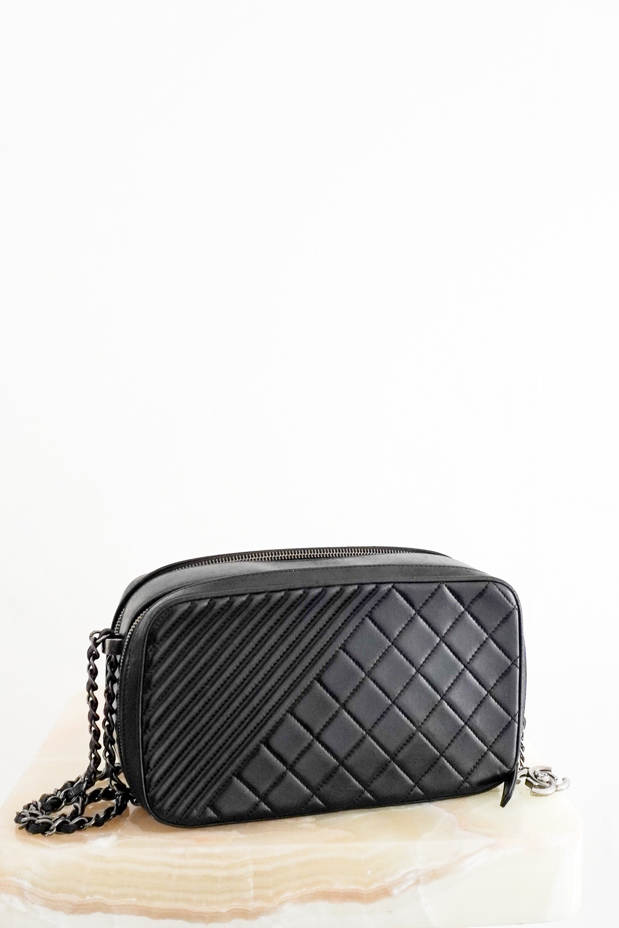 Front photo of a Chanel Cruise 2015 black lambskin camera bag with mixed quilted patterns and chain crossbody strap.