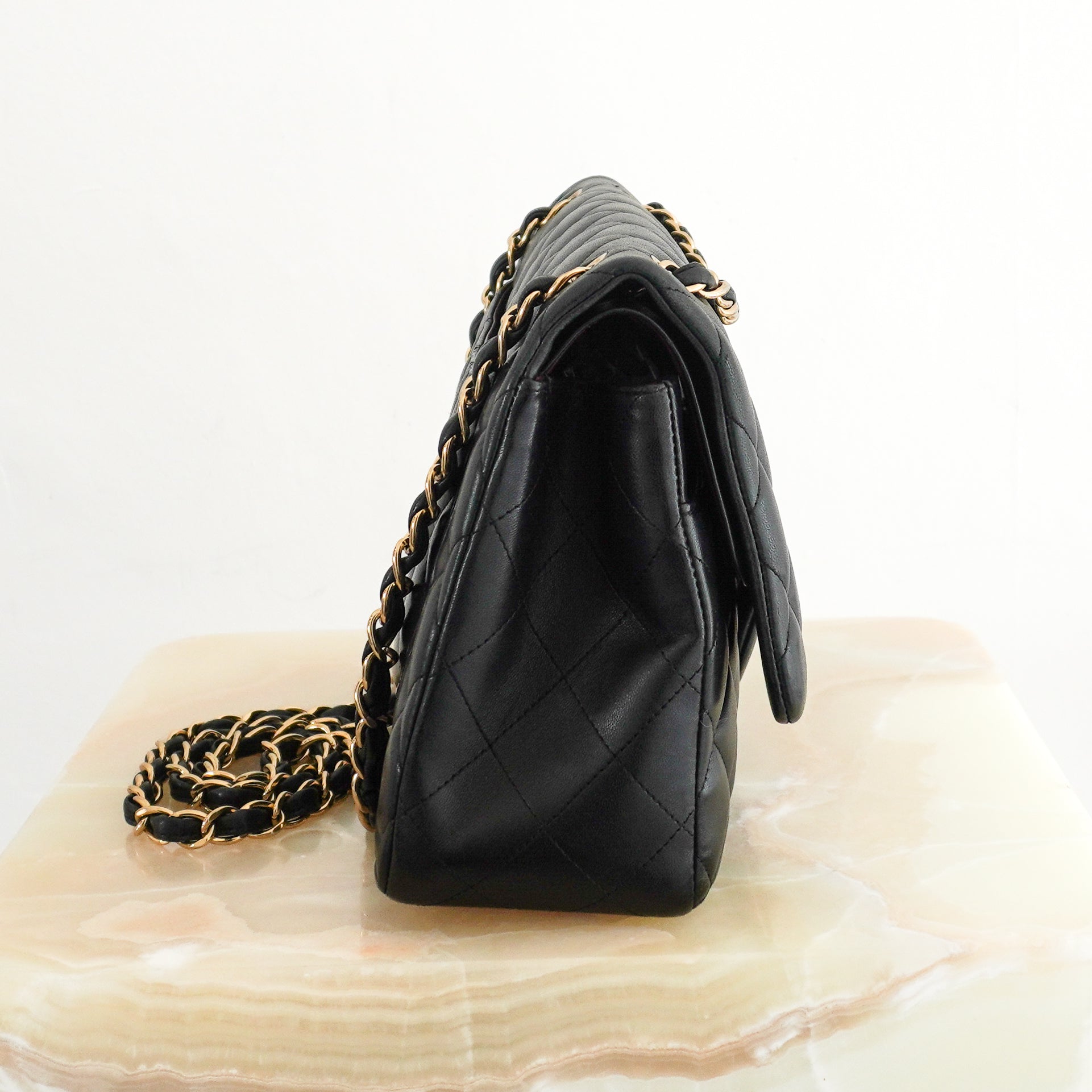 Chanel Jumbo Classic Handbag in Black Lambskin Leather with Gold-Tone Hardware side photo chelsea london
