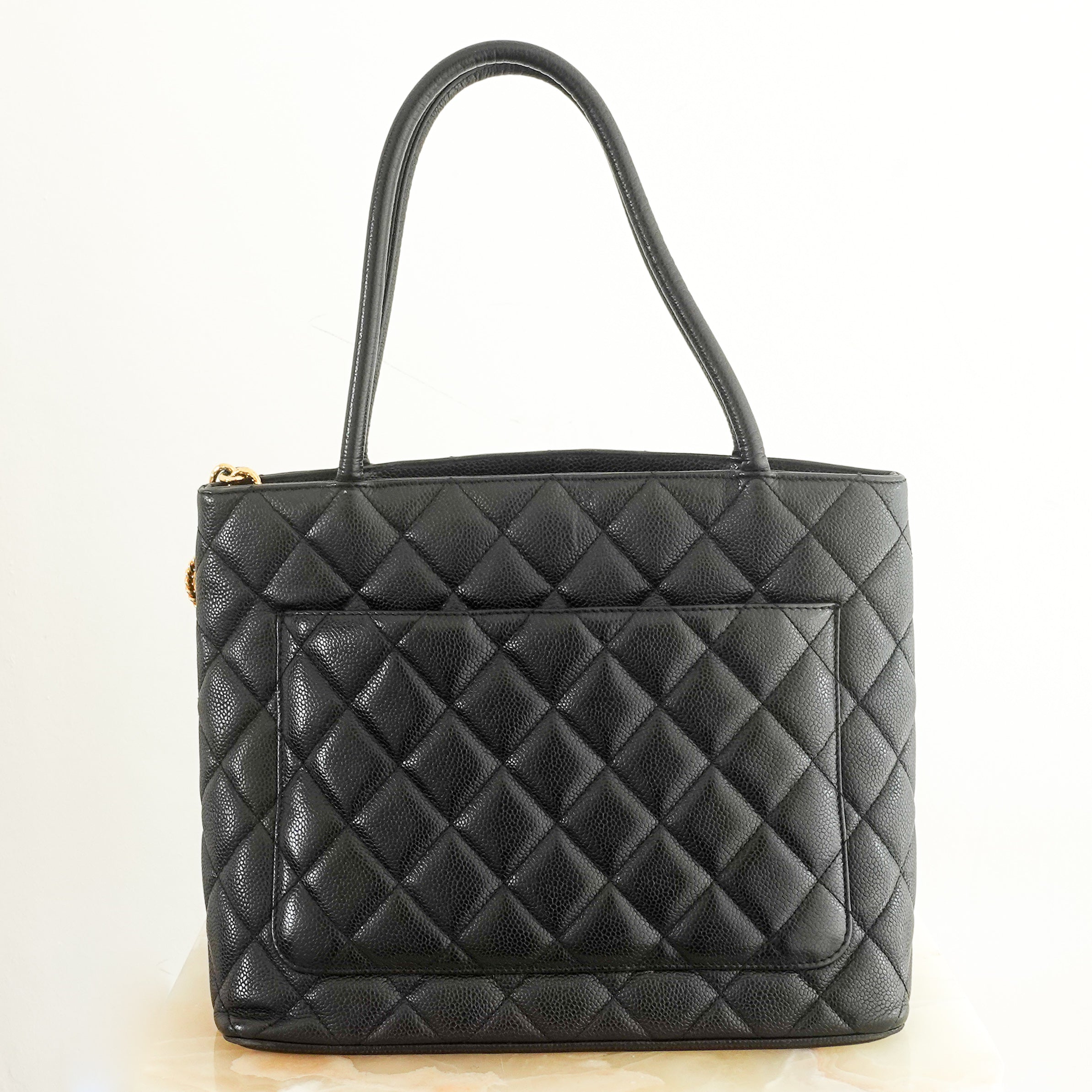 Medaillon handbag in black quilted grained leather