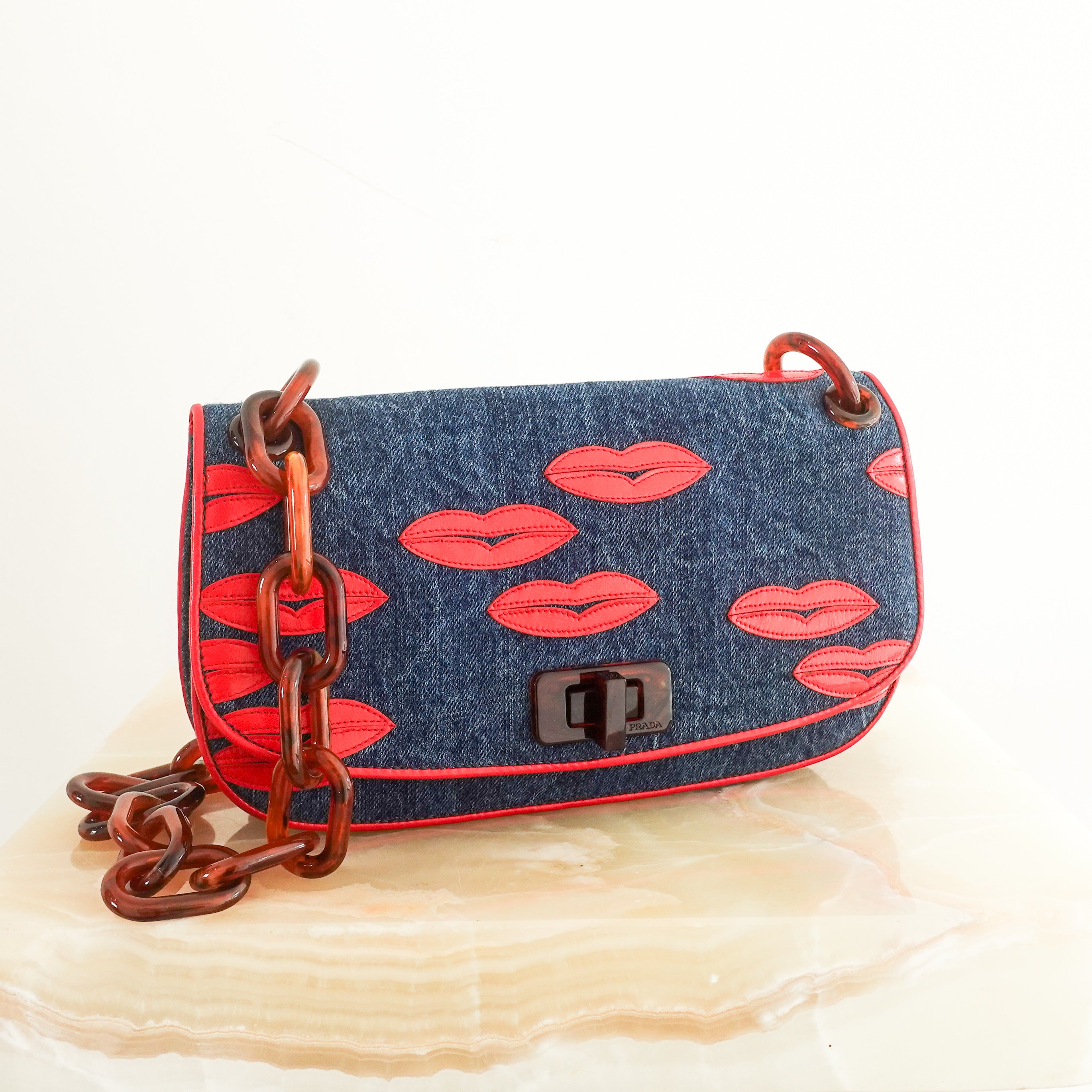 denim lip motif clutch