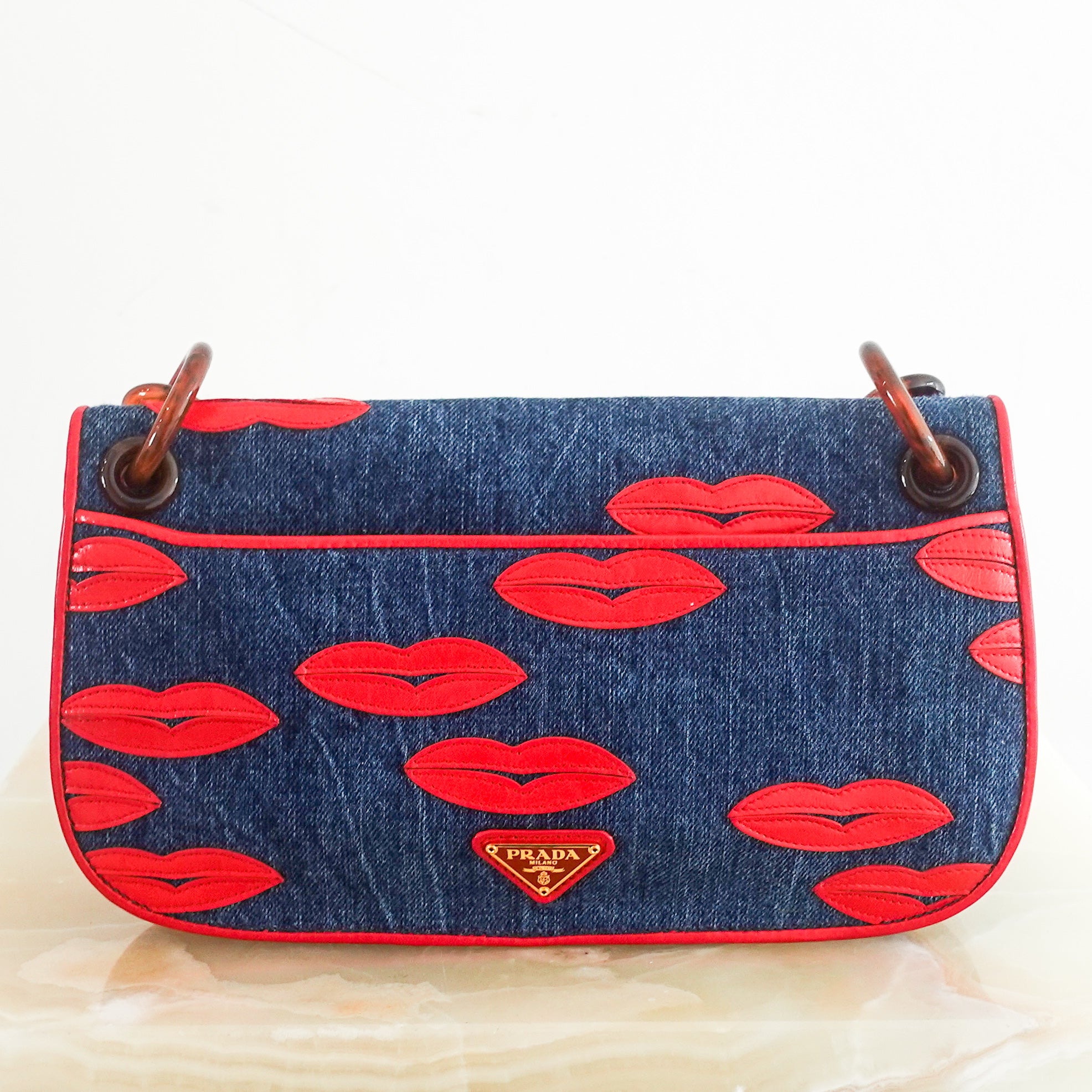 denim lip motif clutch