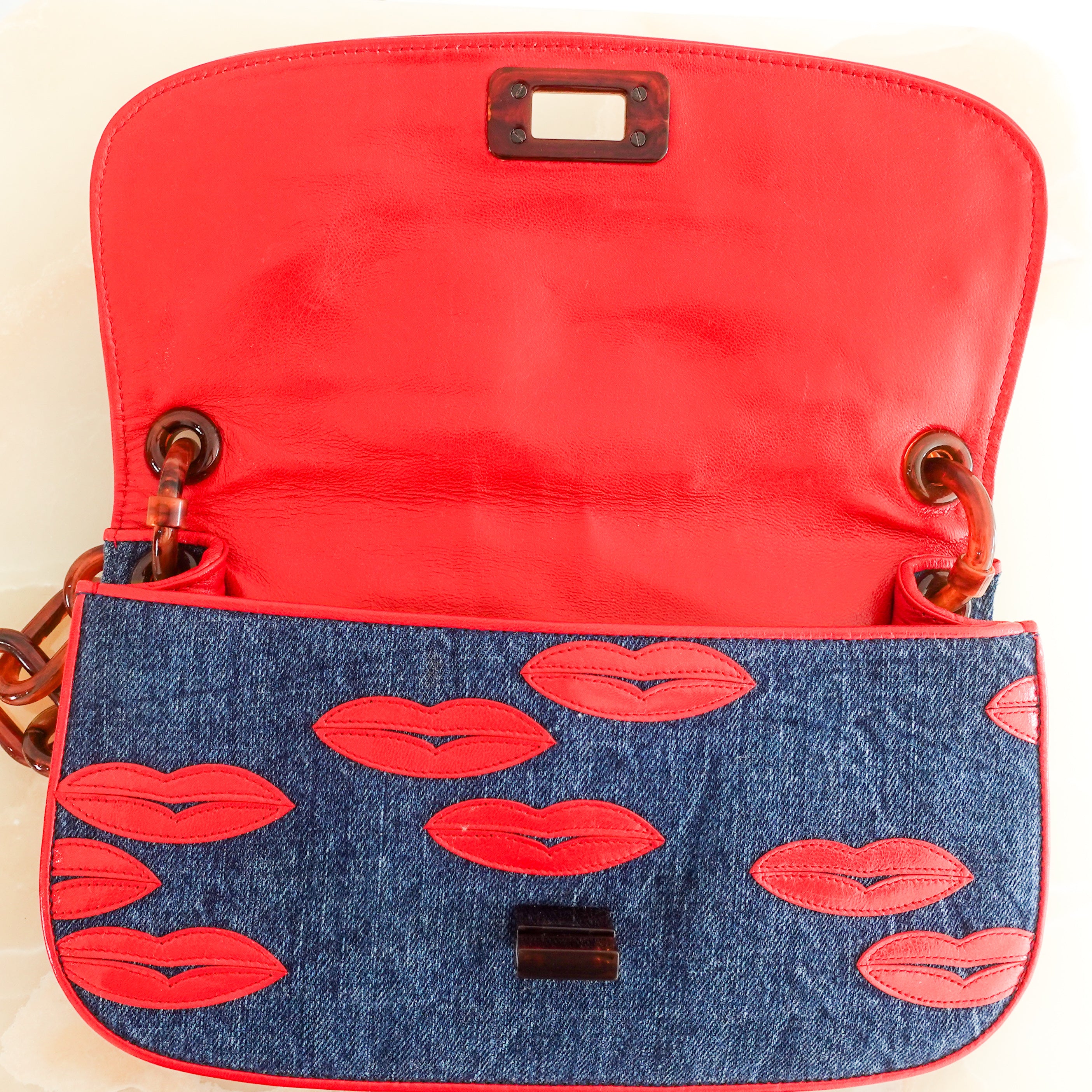 denim lip motif clutch