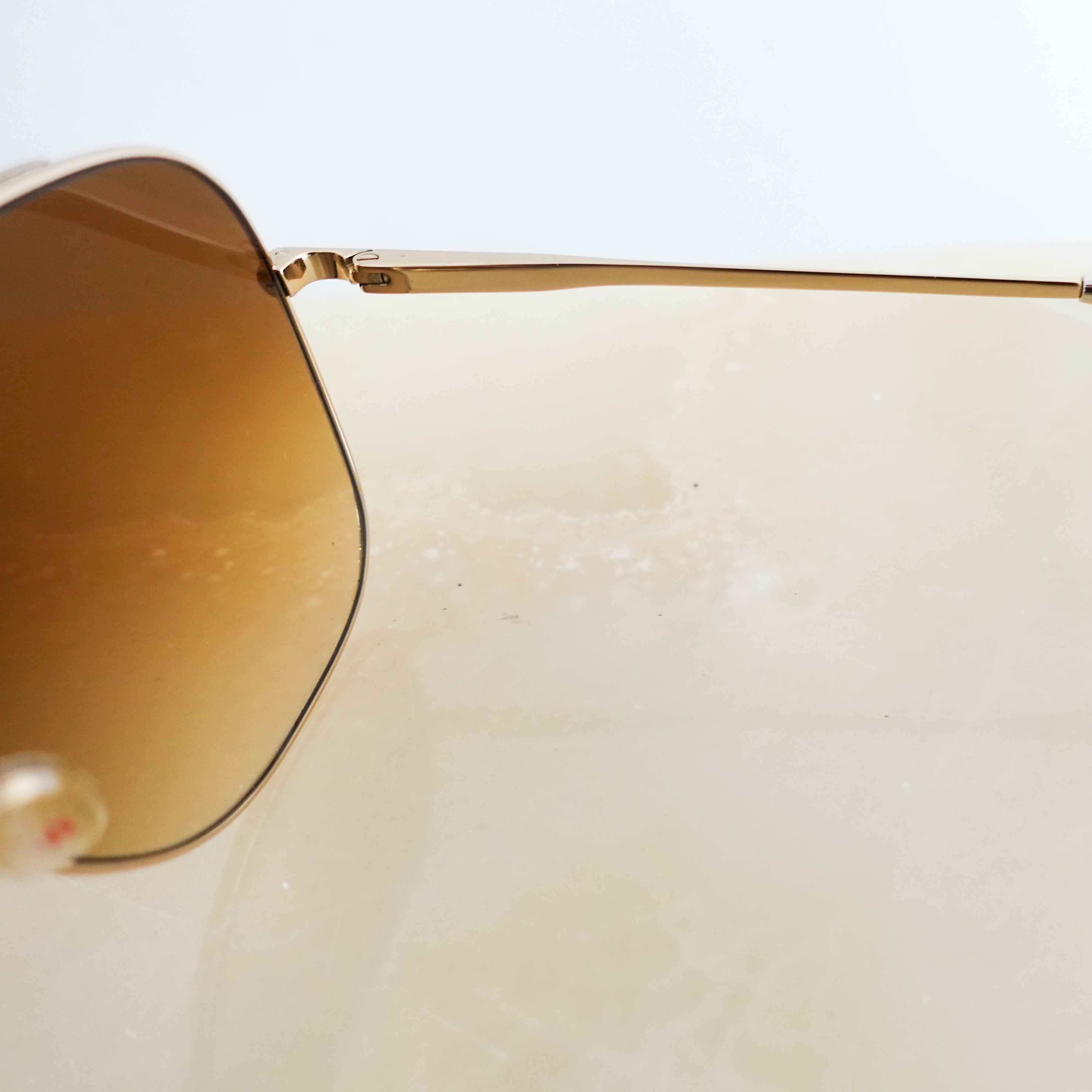 Brown and gold aviator sunglasses