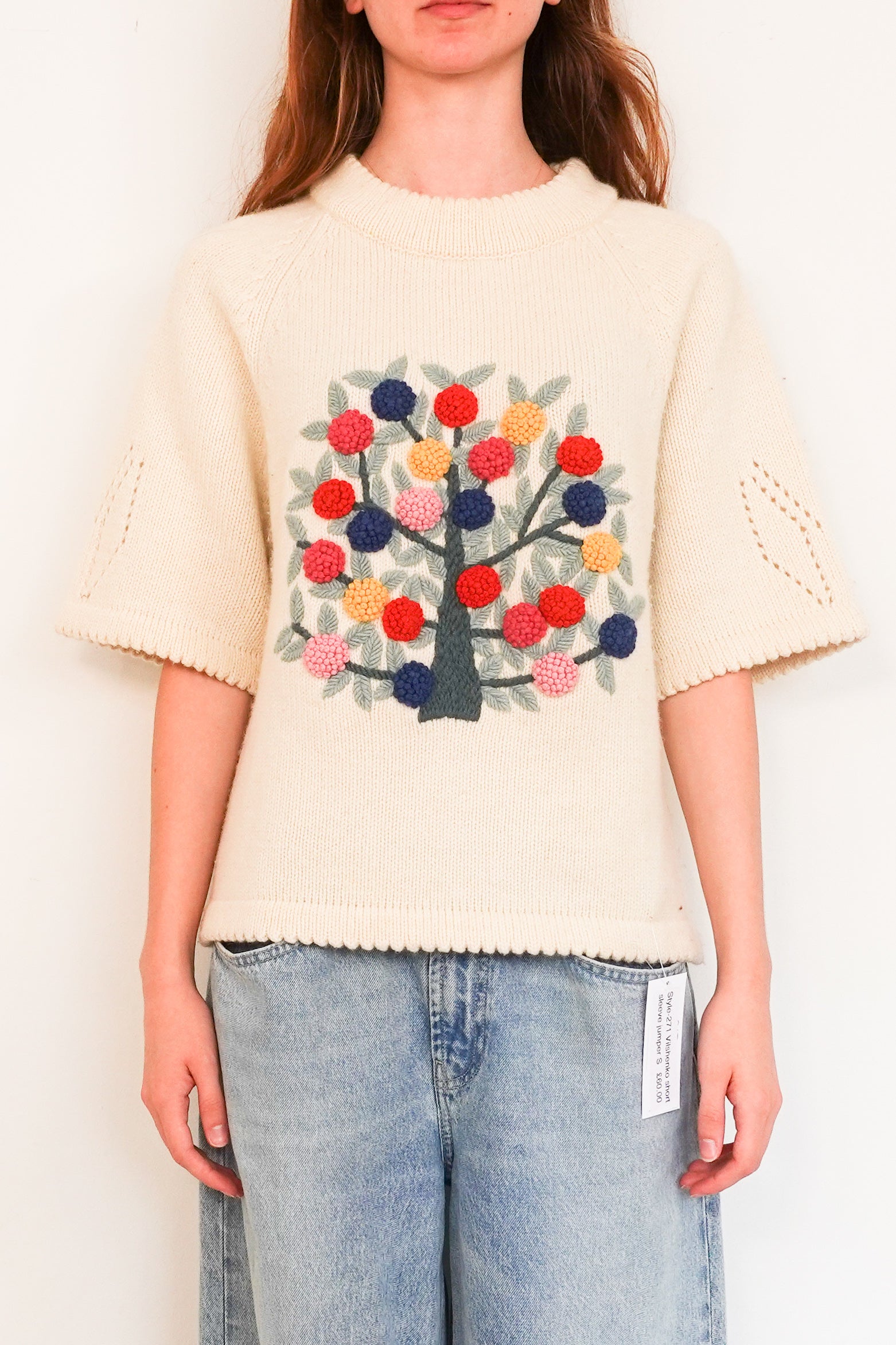 Knitted sweater with embroidered appliqué