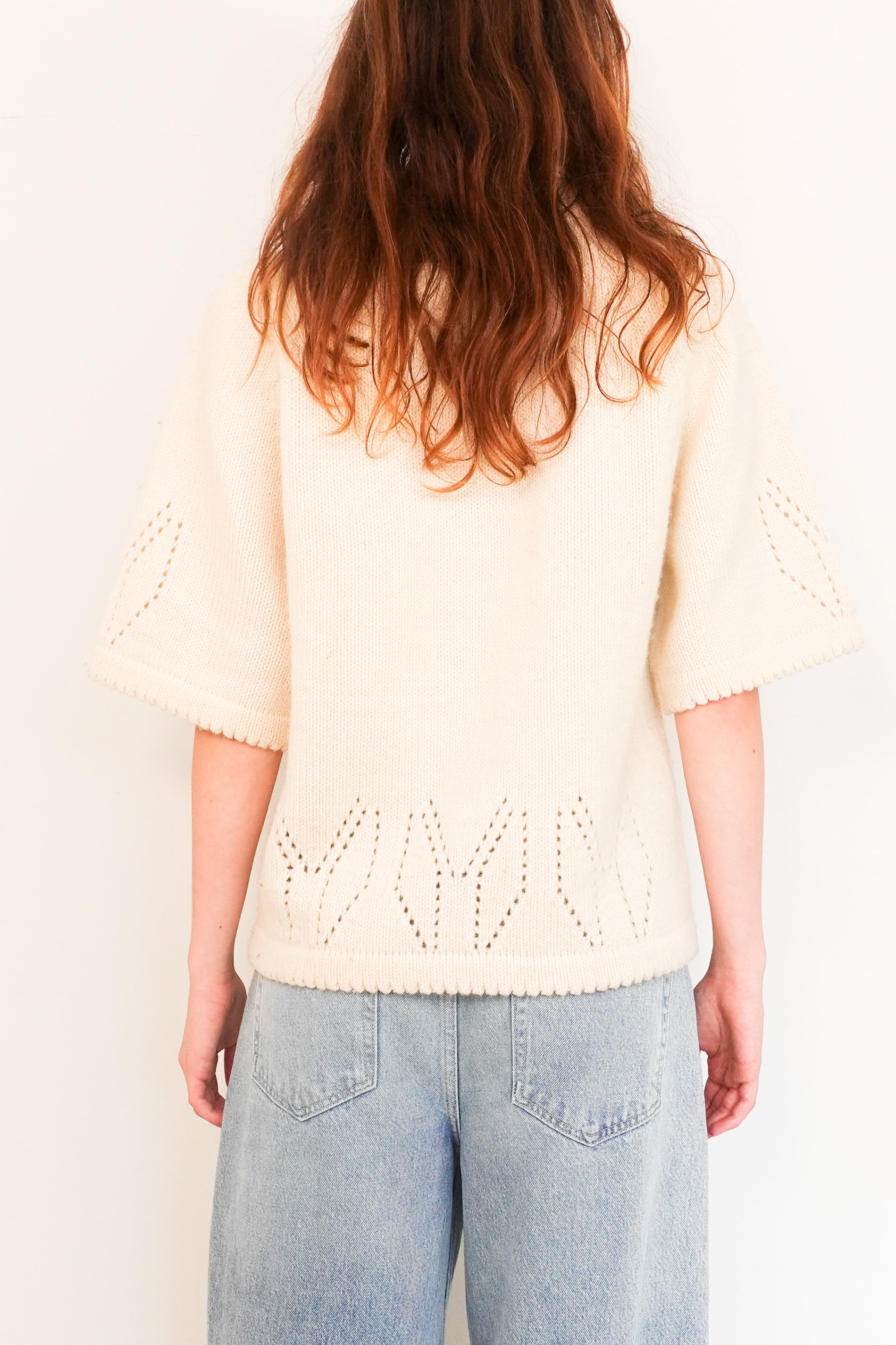 Knitted sweater with embroidered appliqué