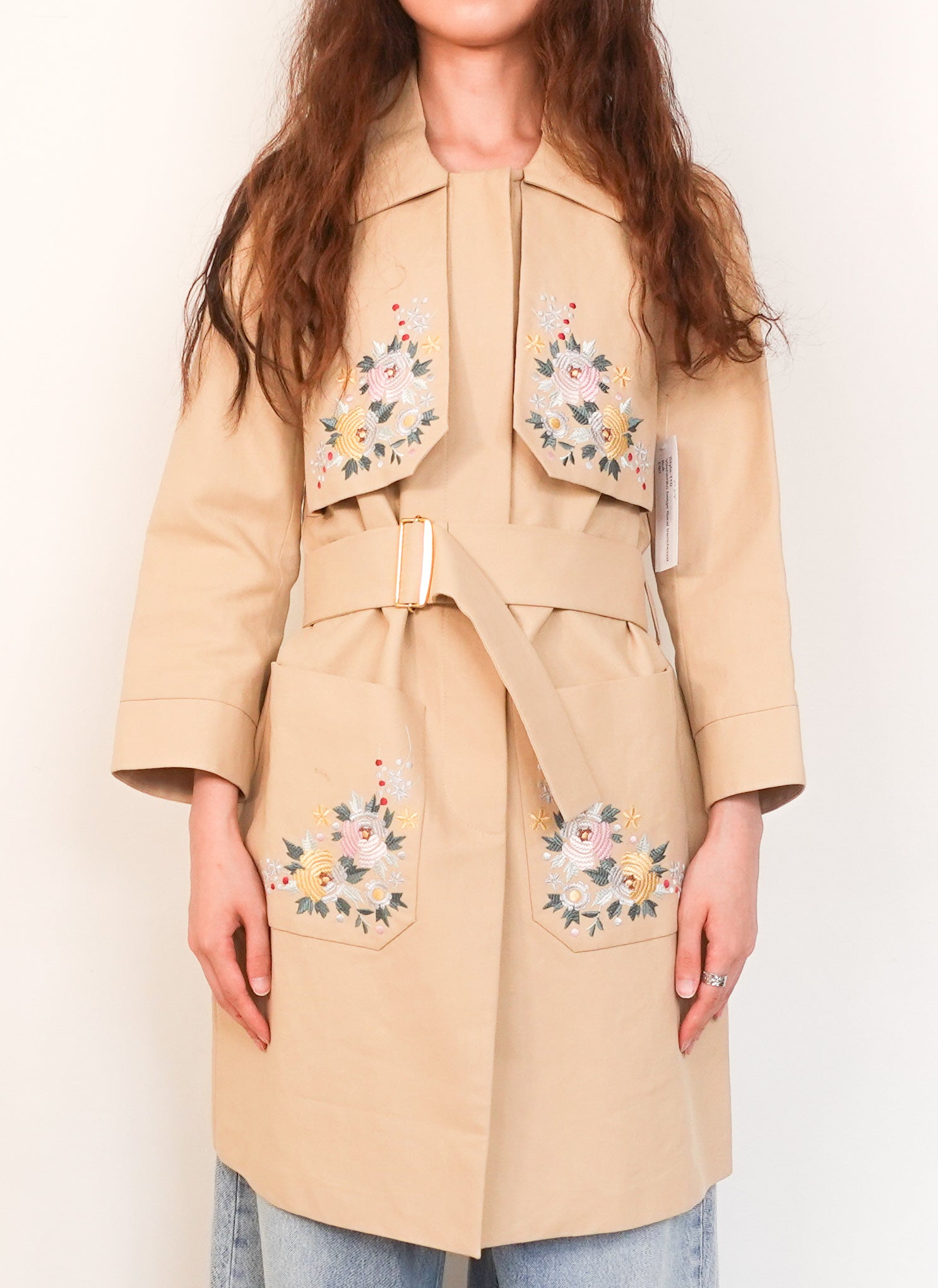 Beige trench coat with colourful floral embroidery