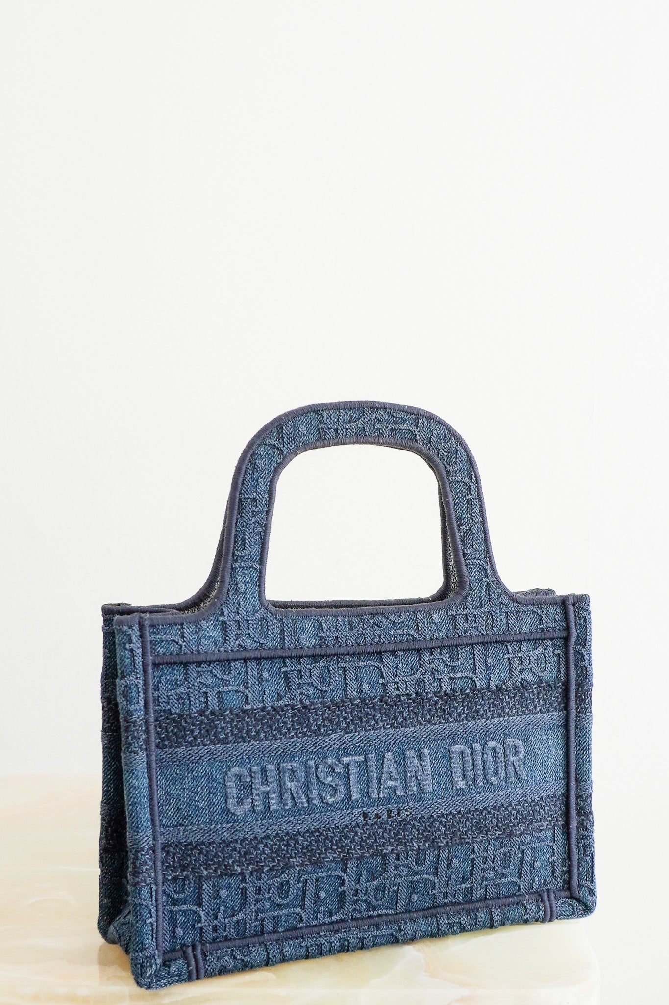 Front image of the Dior Oblique Embroidered Denim Mini Book Bag