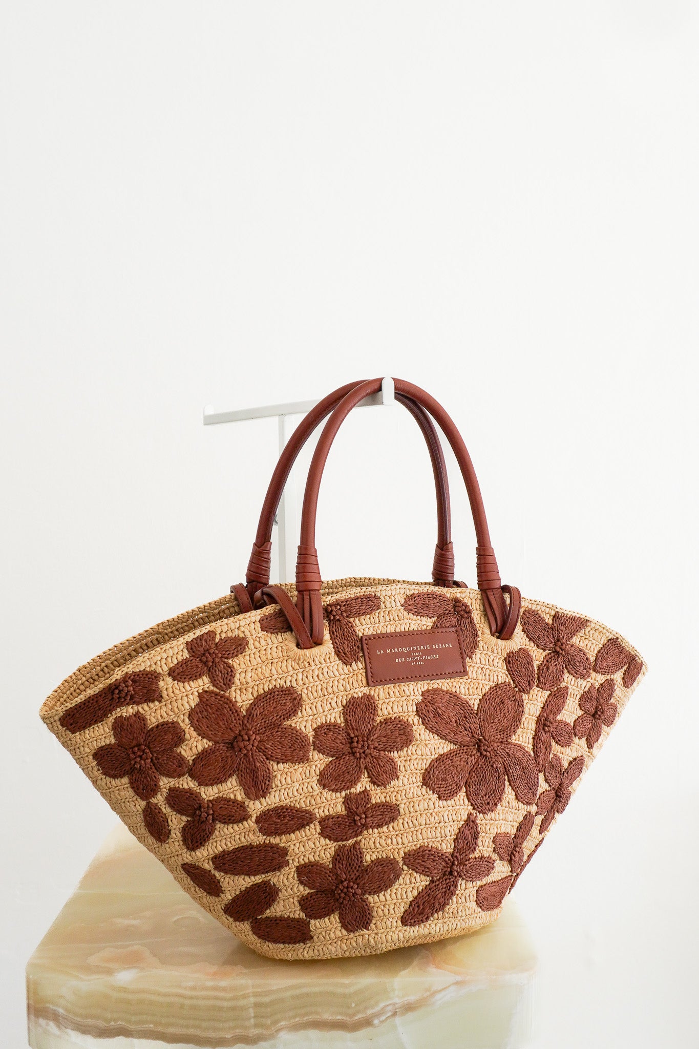 Front image of the Sezane Justine Raffia Bag with Chocolate Embroidered Flowers Chelsea London