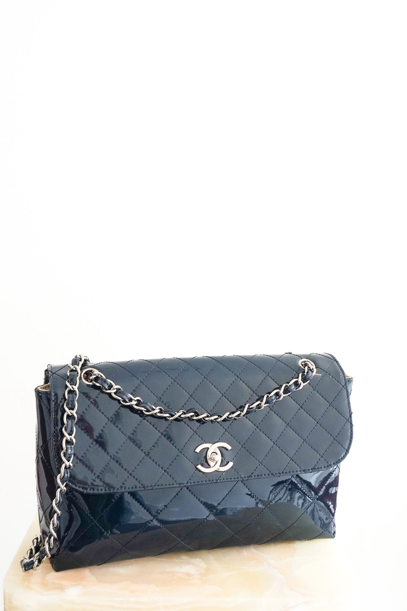 Front photo of the Chanel Jumbo Patent Leather Flap Bag in Navy Chelsea London