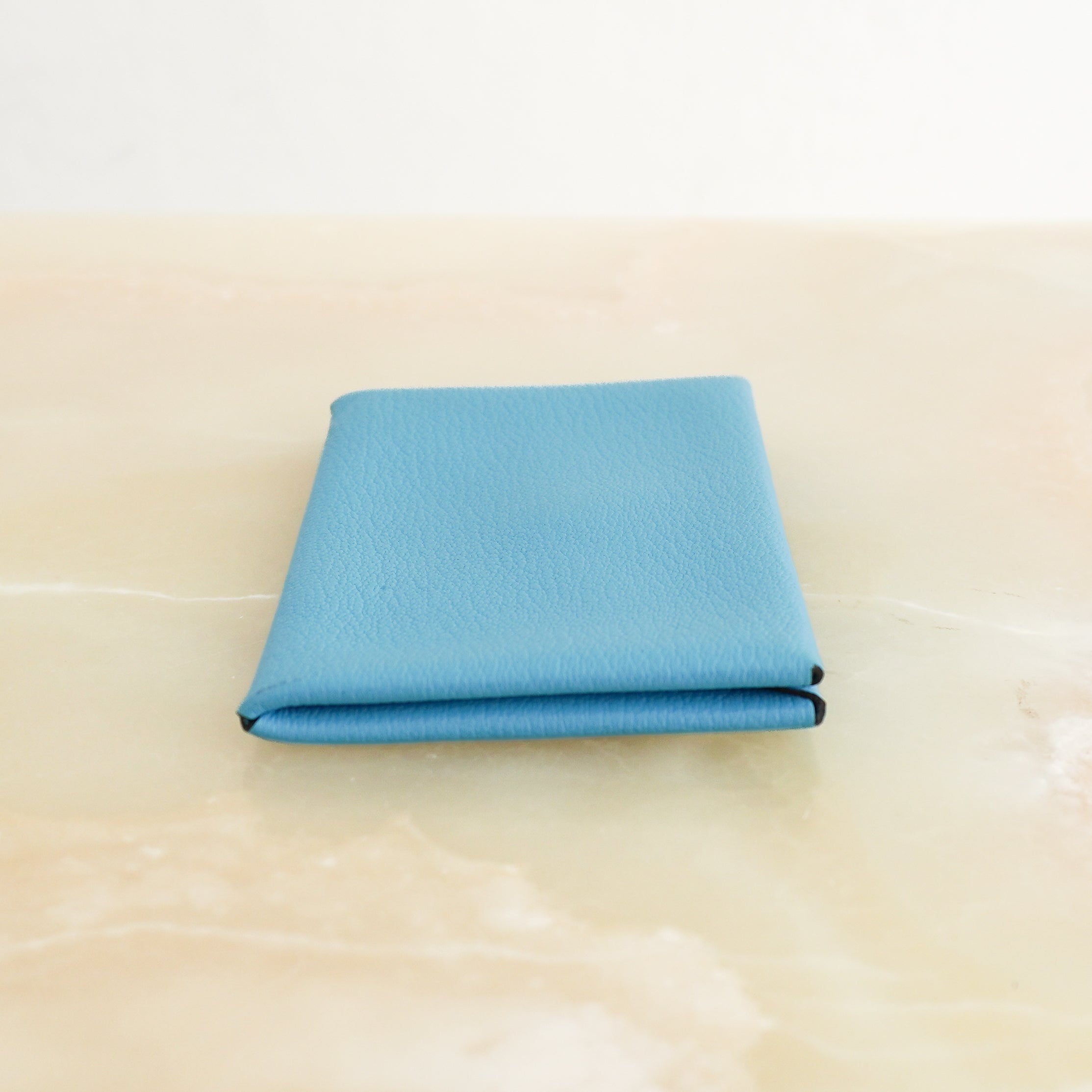 Hermès Calvi Card Holder in Blue Chevre Mysore Leather side photo chelsea london