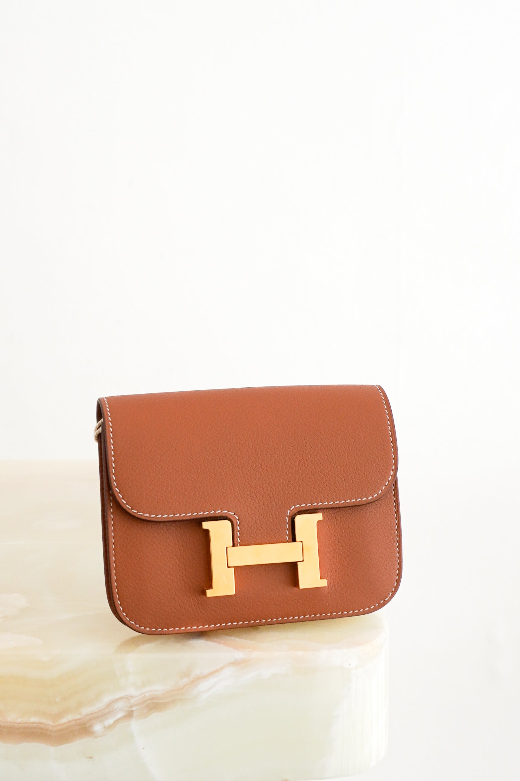 Hermès Constance Slim Wallet with Crossbody Strap in Gold front photo chelsea london