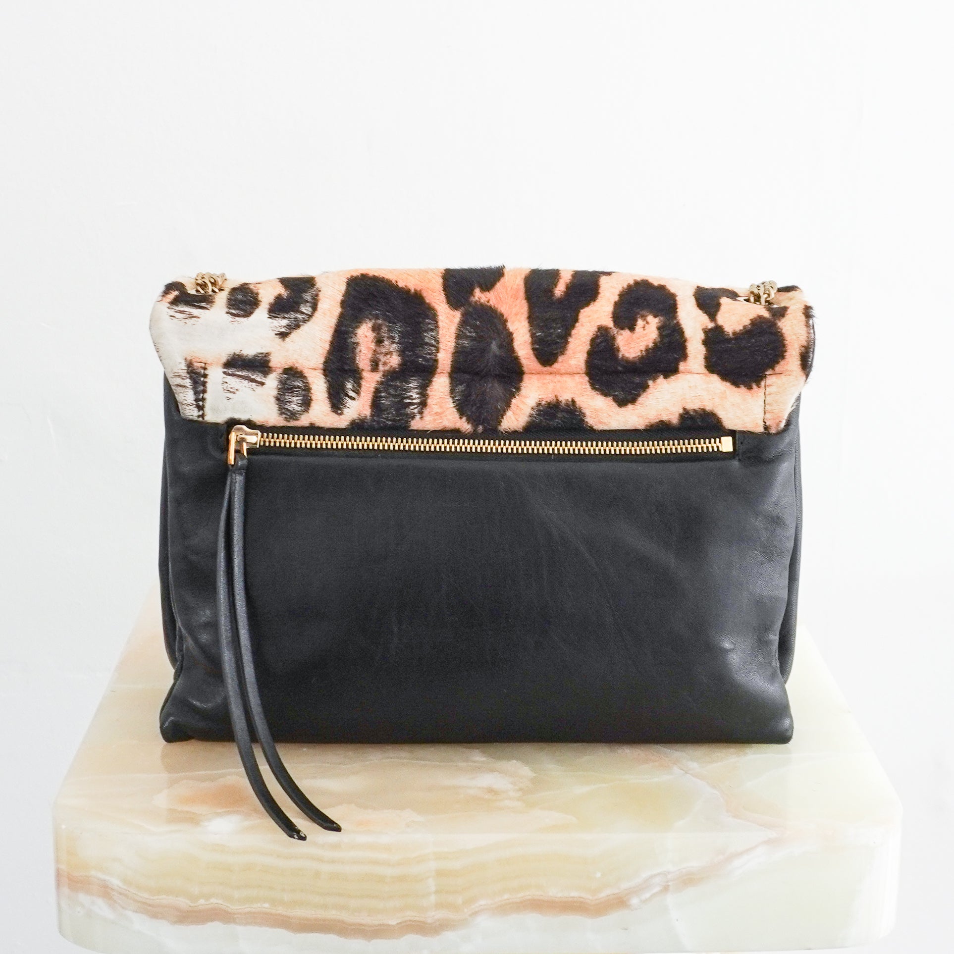 Back view photo of a Lanvin Leopard Print Pony Hair & Leather Bag, showcasing its bold leopard pattern flap and delicate gold-tone chain strap