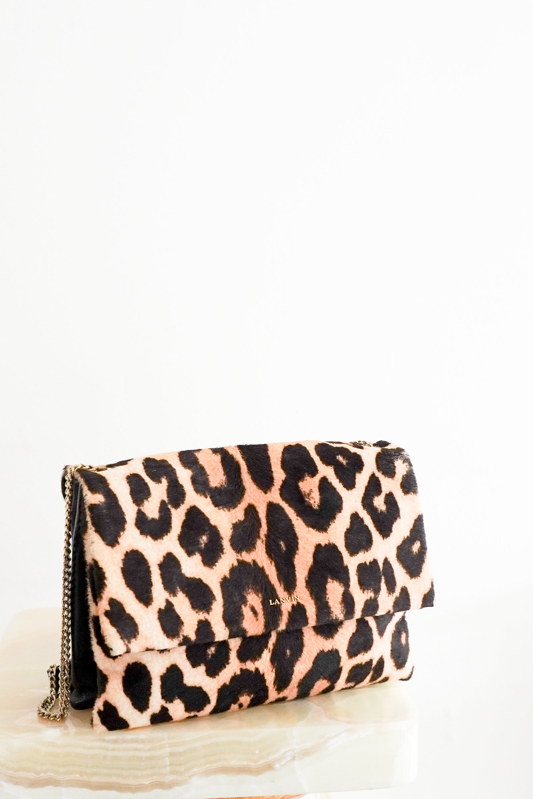 Front view photo of a Lanvin Leopard Print Pony Hair & Leather Bag, showcasing its bold leopard pattern flap and delicate gold-tone chain strap