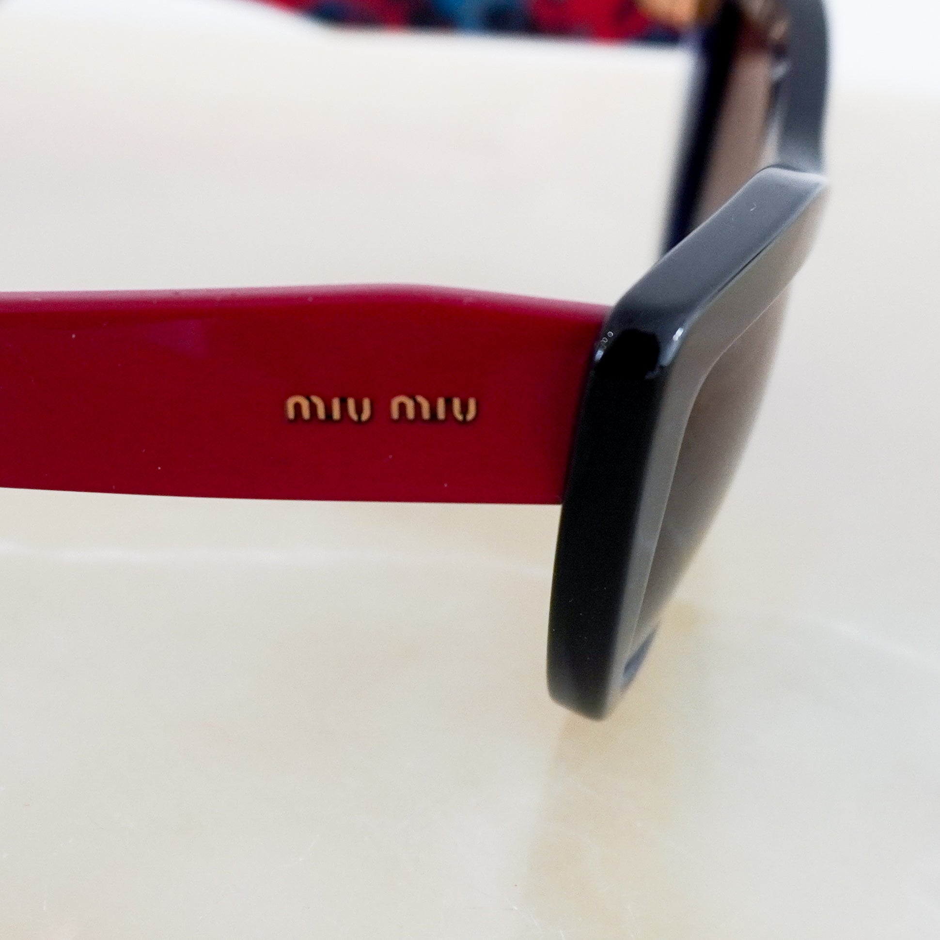 Miu-Miu-Black-&-Red-Cateye-Sunglasses-logo-picture